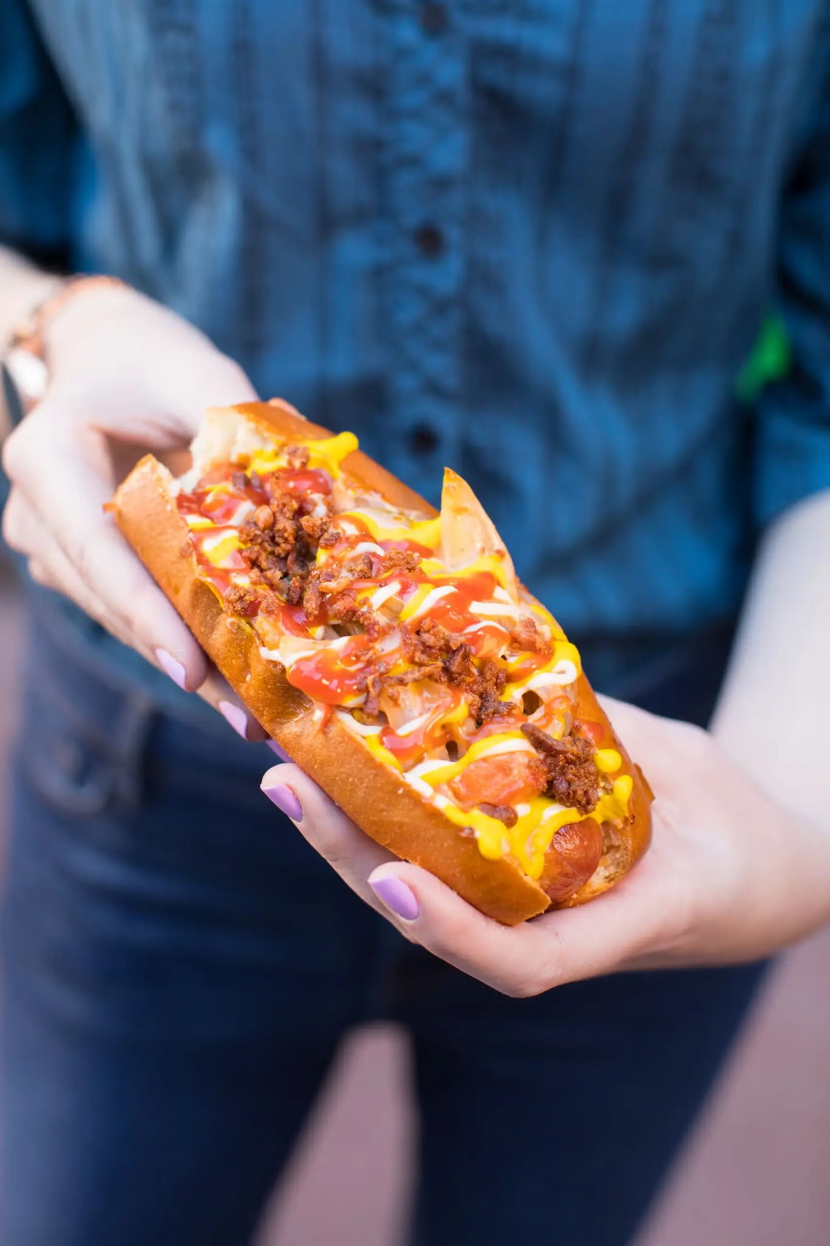 Dirt Dog #Housedogs bacon-wrapped hot dog covered in cream cheese, cheddar, roasted green chiles, thousand island dressing, grilled peppers, and onions
