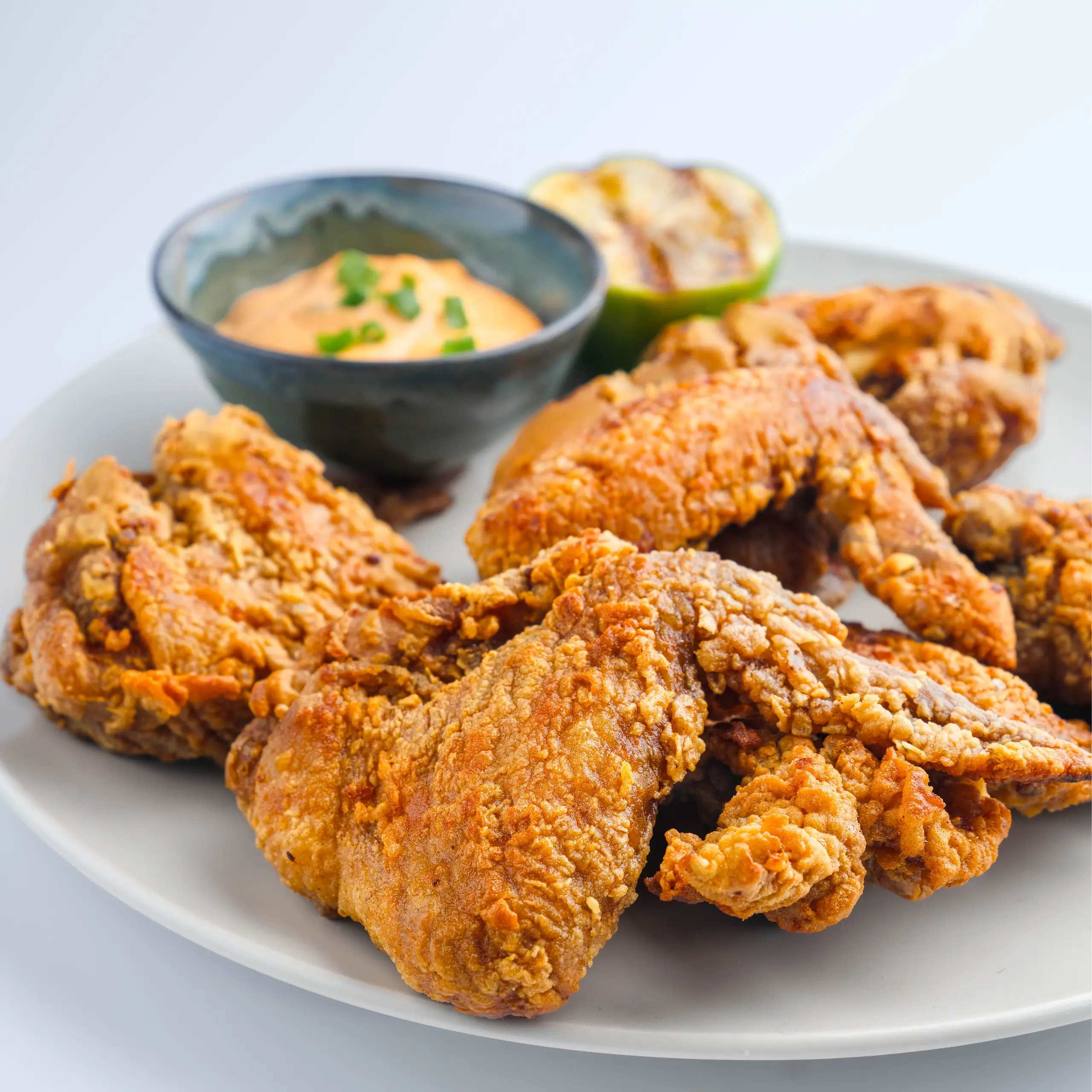 Crispy chicken wings marinated in ginamos
