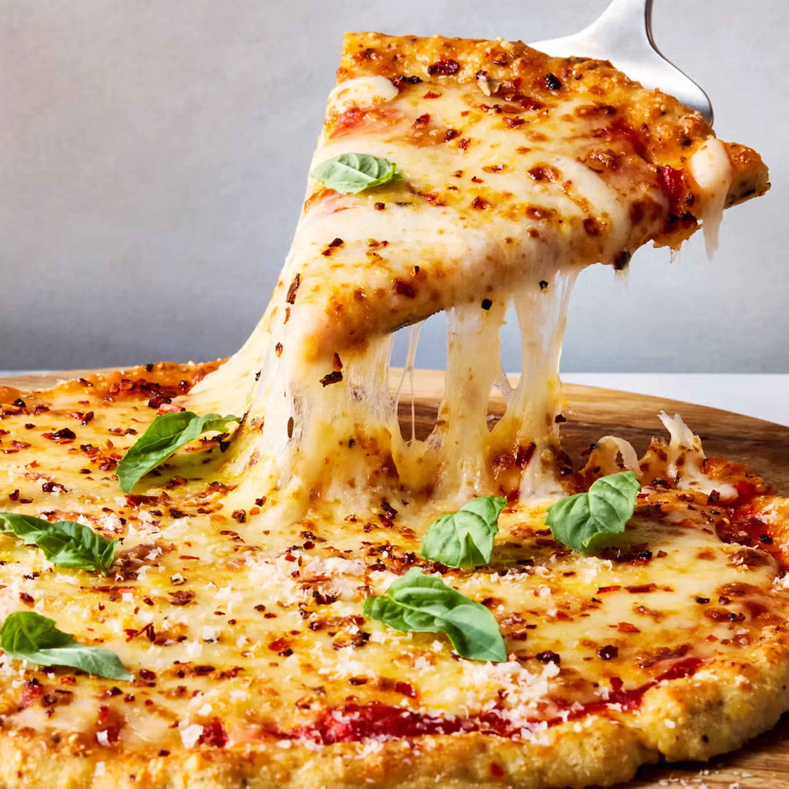 picture of a pizza made out of chicken and parmesan with marinara sauce mozzarella and basil