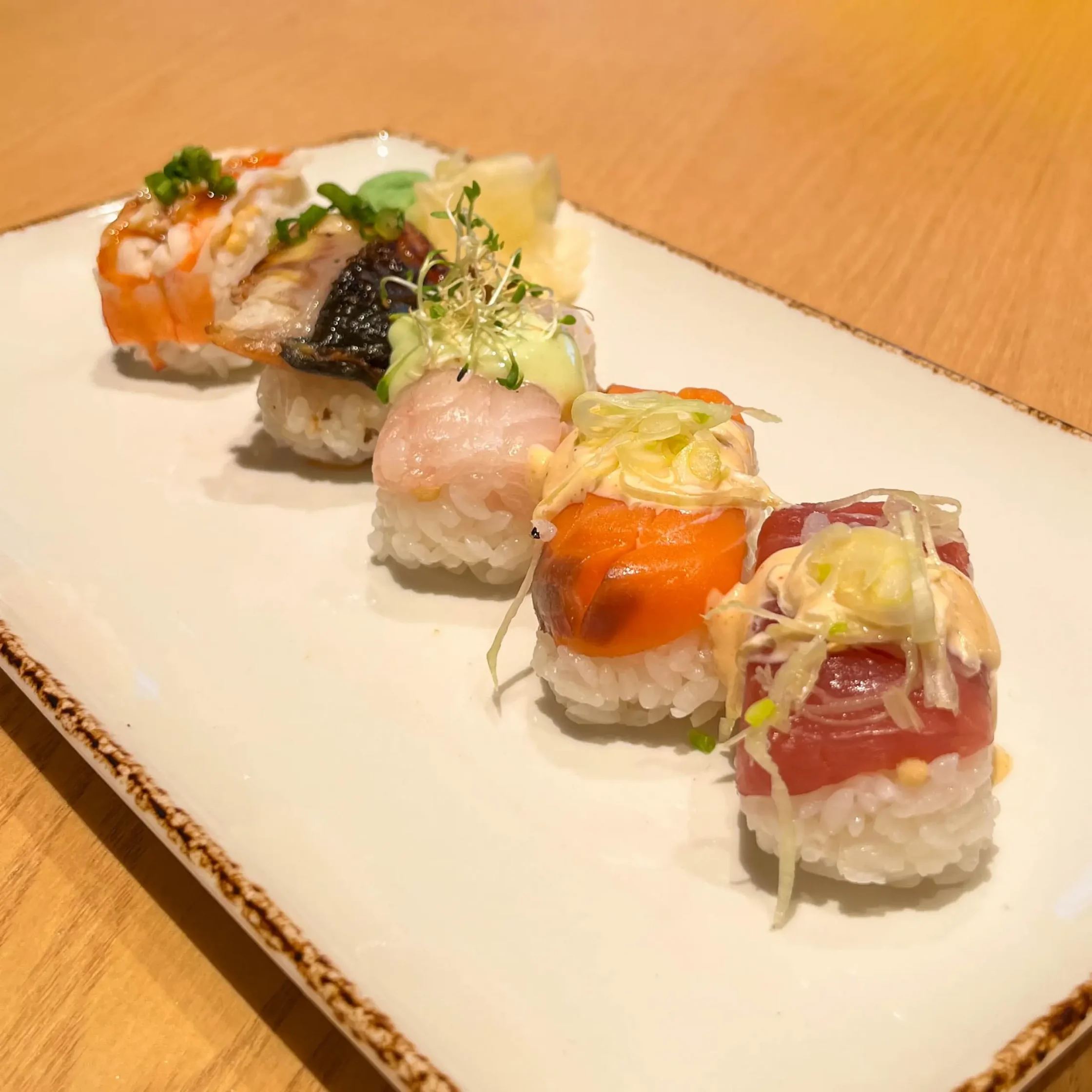 Ootoya’s assorted sushi tray featuring a variety of fresh nigiri sushi topped with salmon, tuna, shrimp, and other seafood, served on a rectangular plate.