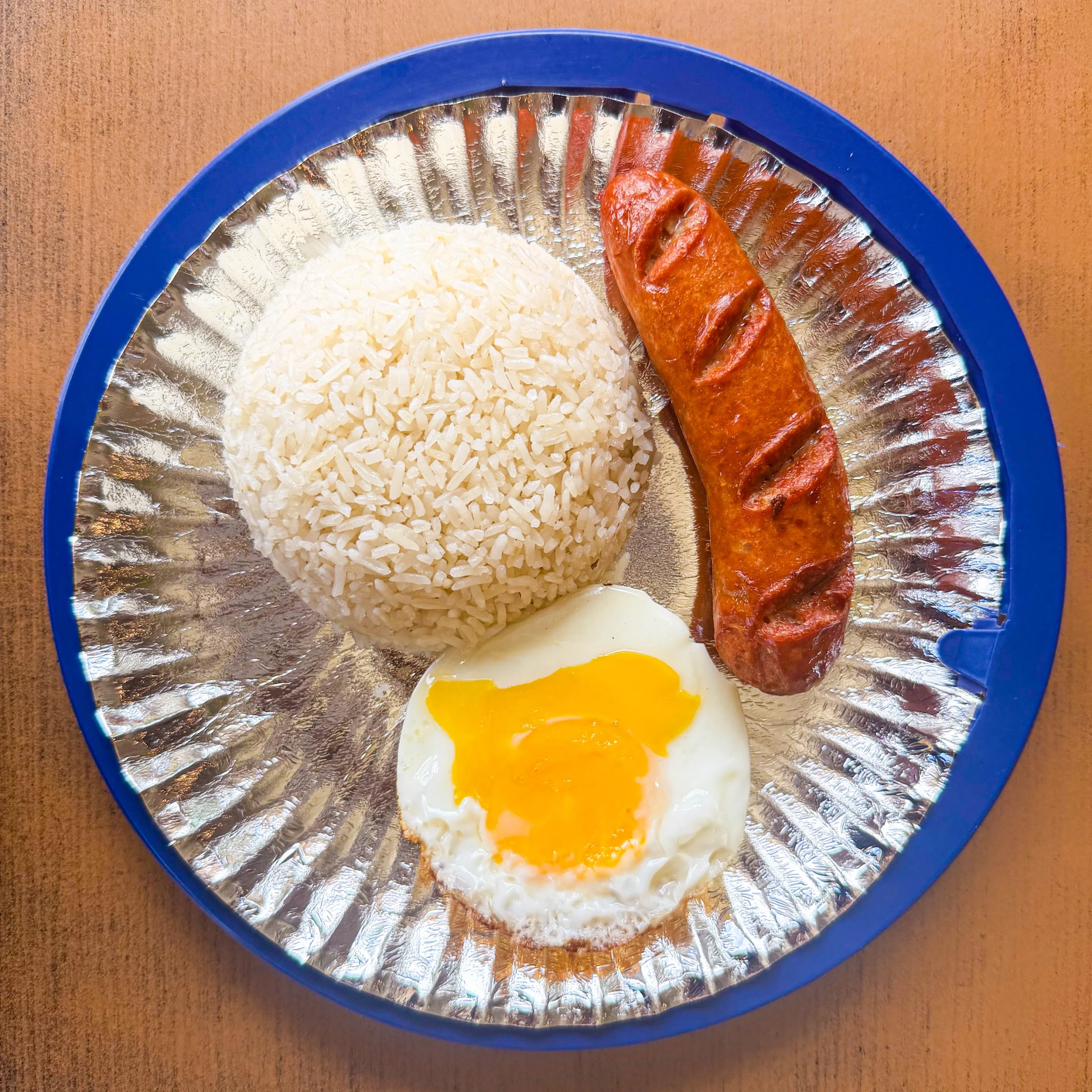Atoy’s Hungarian sausage silog meal with grilled Hungarian sausage, steamed rice, and a sunny-side-up egg.