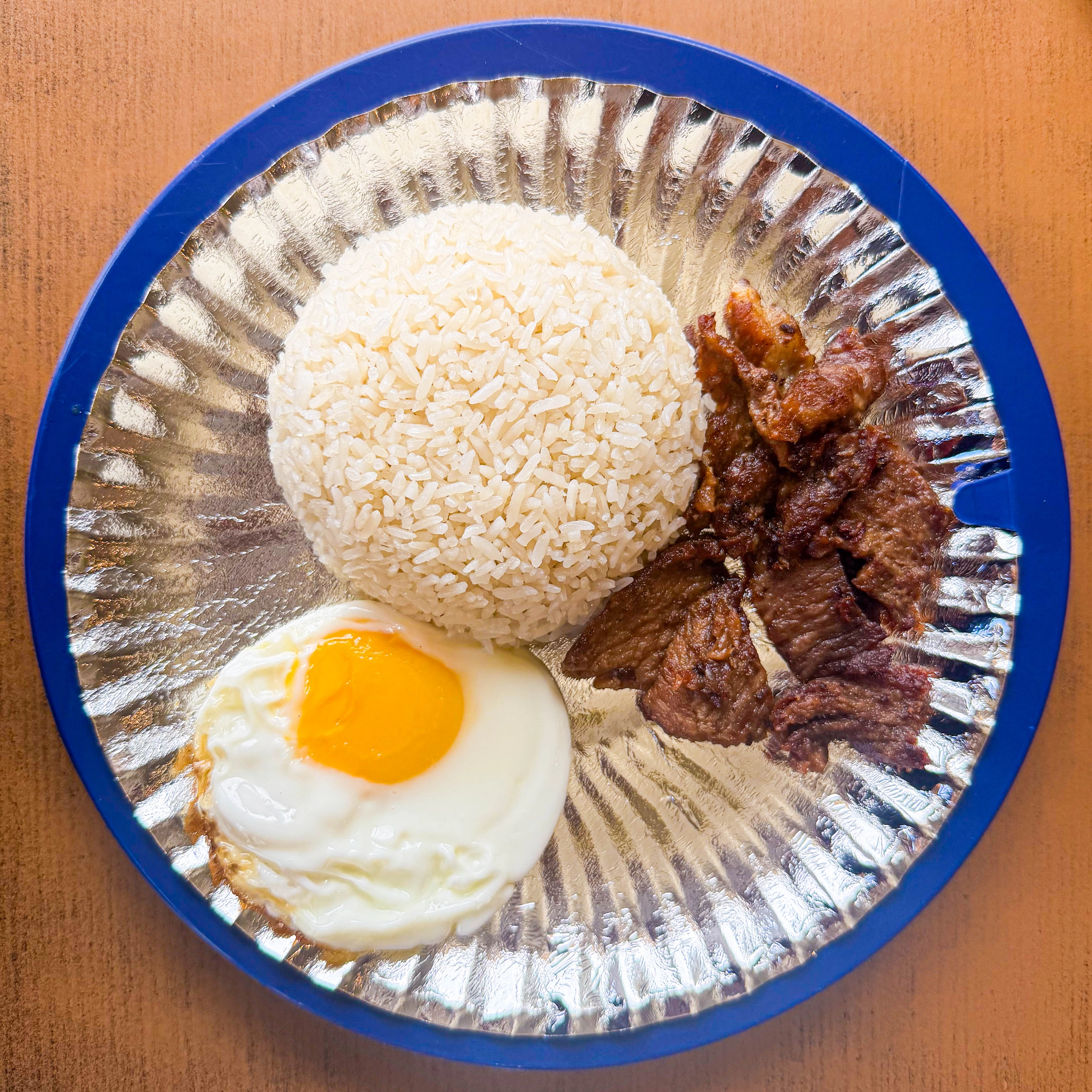 Atoy’s tapsilog meal with beef tapa, steamed rice, and a sunny-side-up egg.