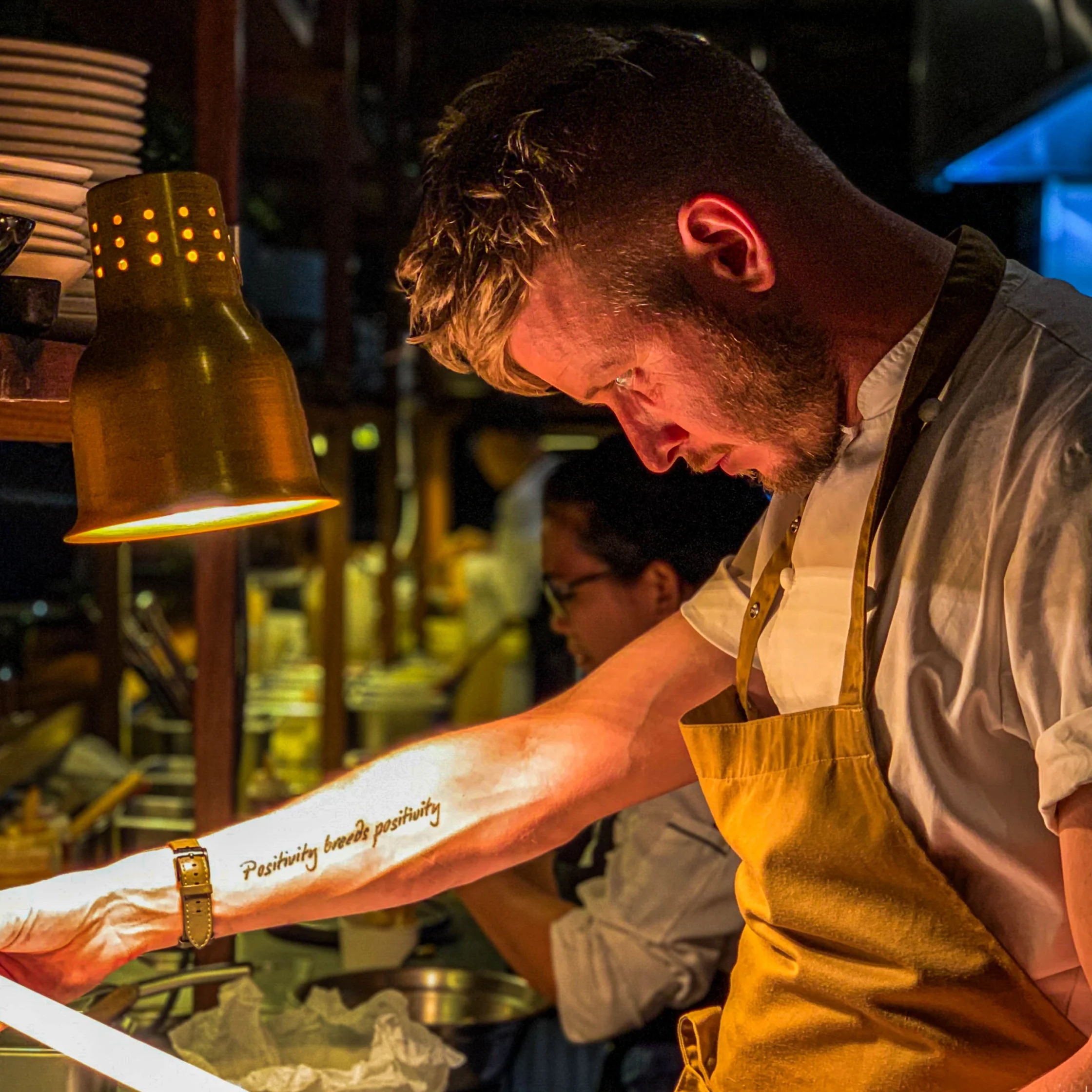 Bartender at The Pig & Palm in Cebu City preparing a cocktail under warm lighting, showcasing the bar’s mixology style and atmosphere.