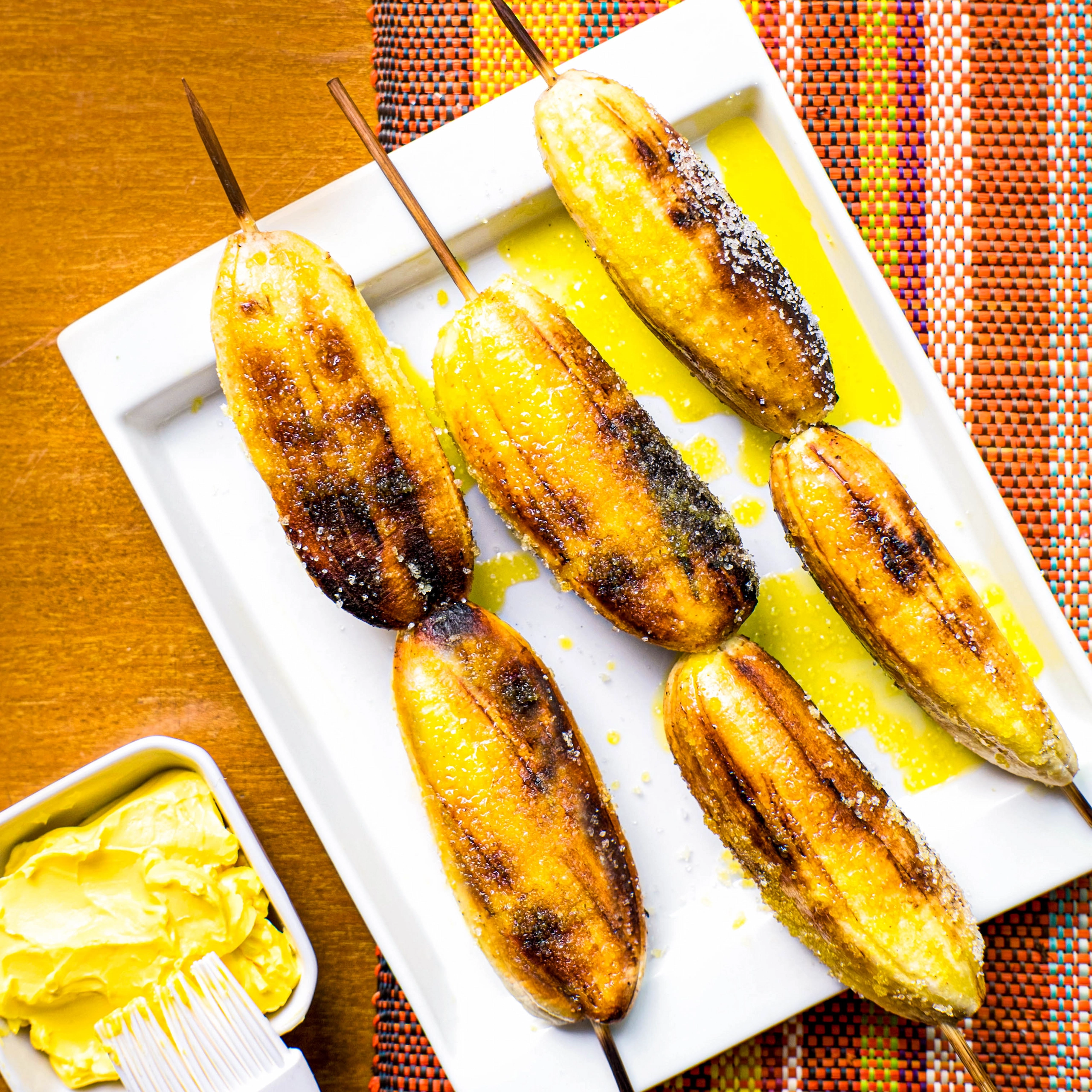 Ginanggang or grilled skewered bananas brushed with margarine and sprinkled with sugar