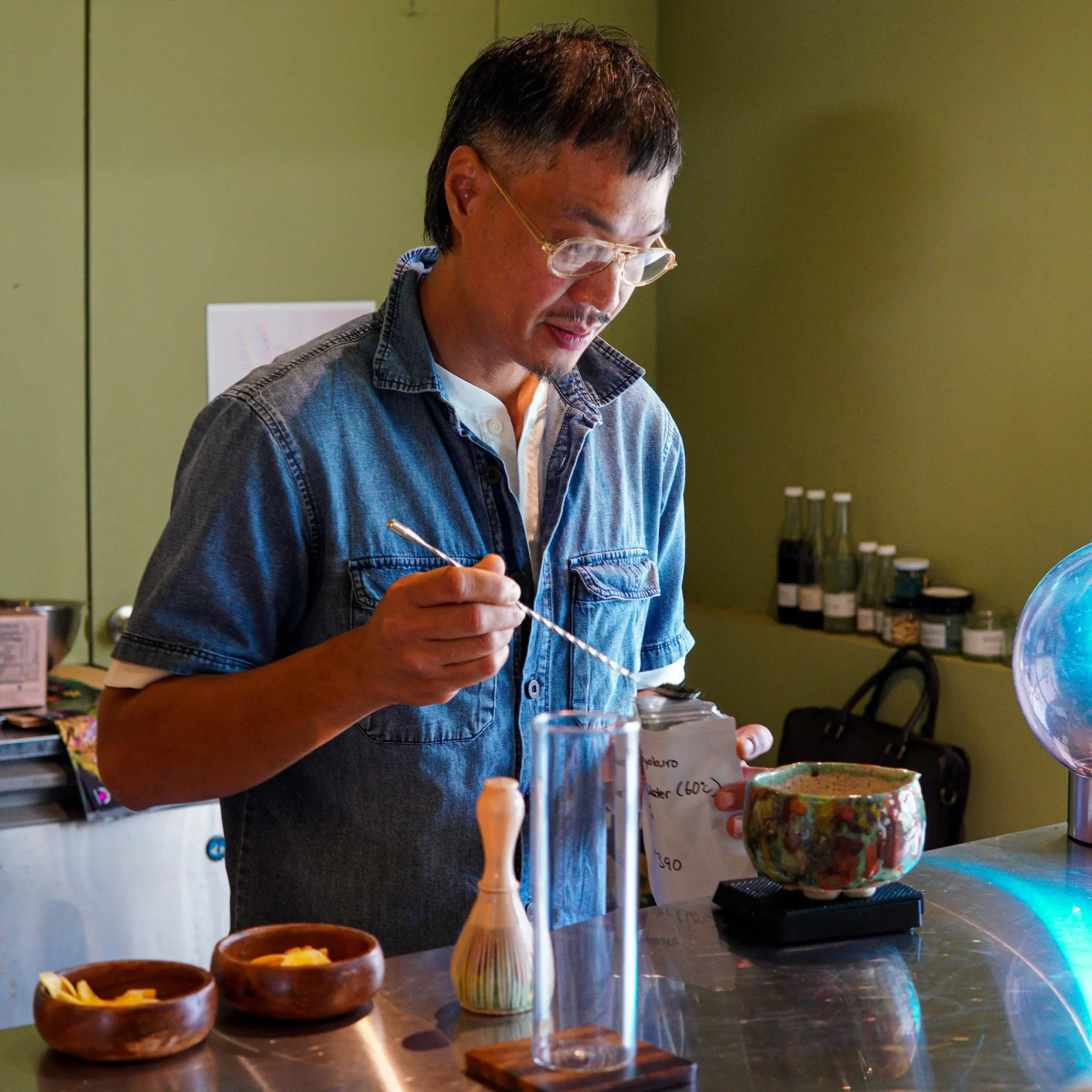 Sly Samonte, brains behind Lost Islands Center for Kape, brewing tea.