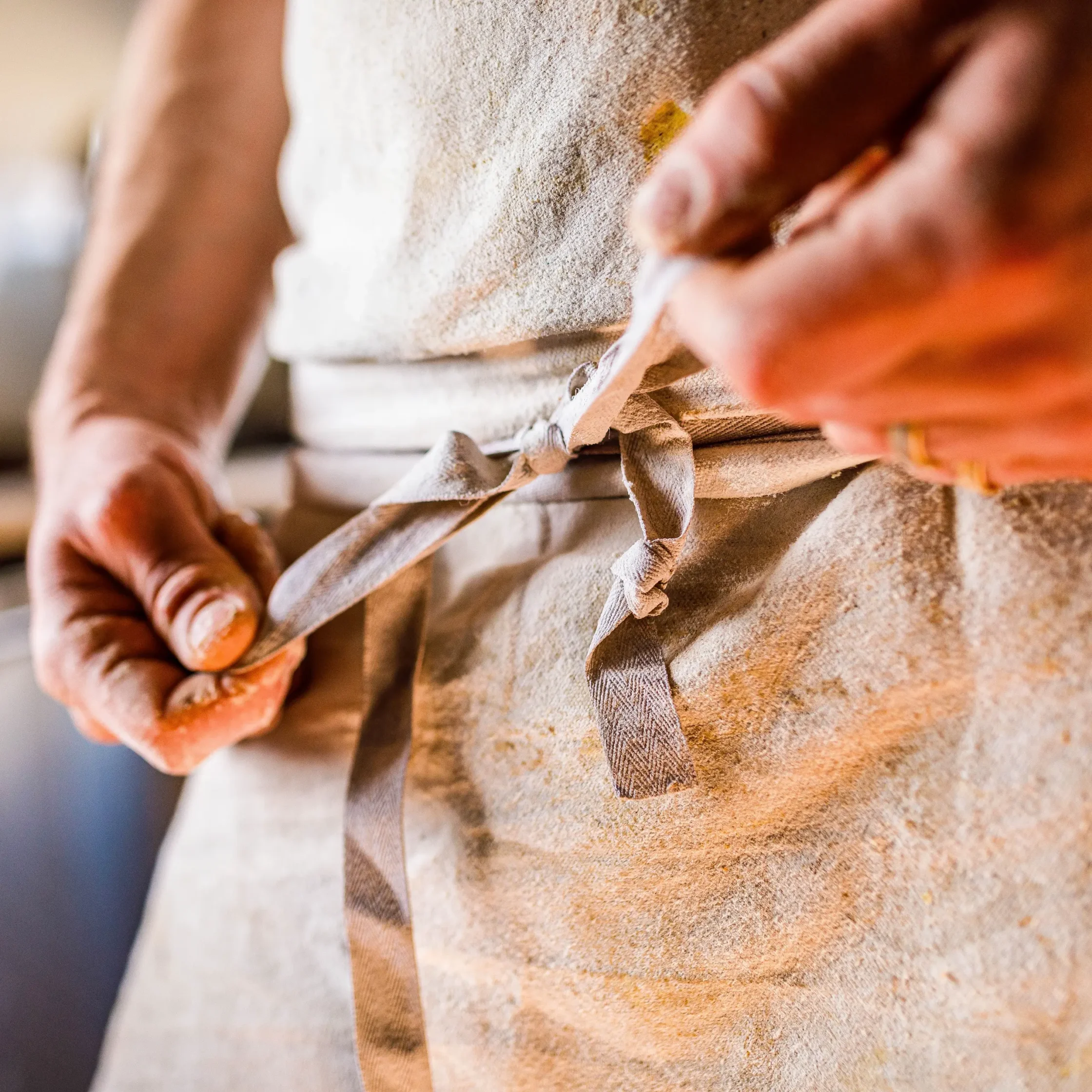 Someone tying an apron
