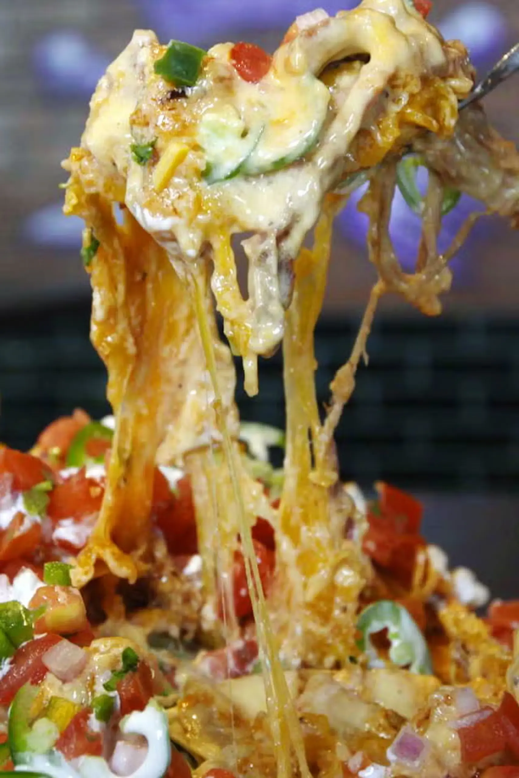 Fieri's nachos corn tortilla chips pulled pork, cheese sauce, jalapeños, crema, pico de gallo, and barbecue sauce