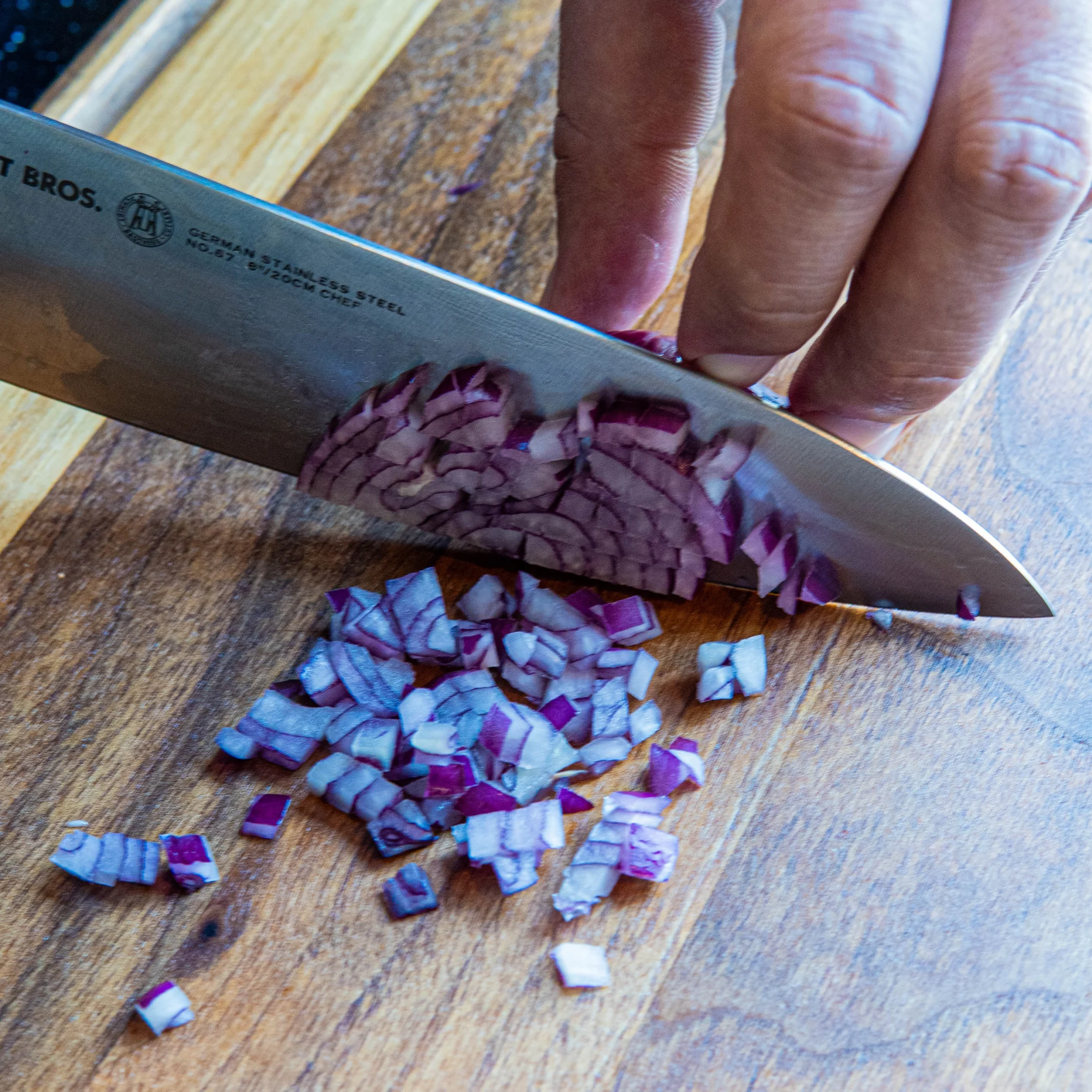 onions being diced into small cubes for cooking