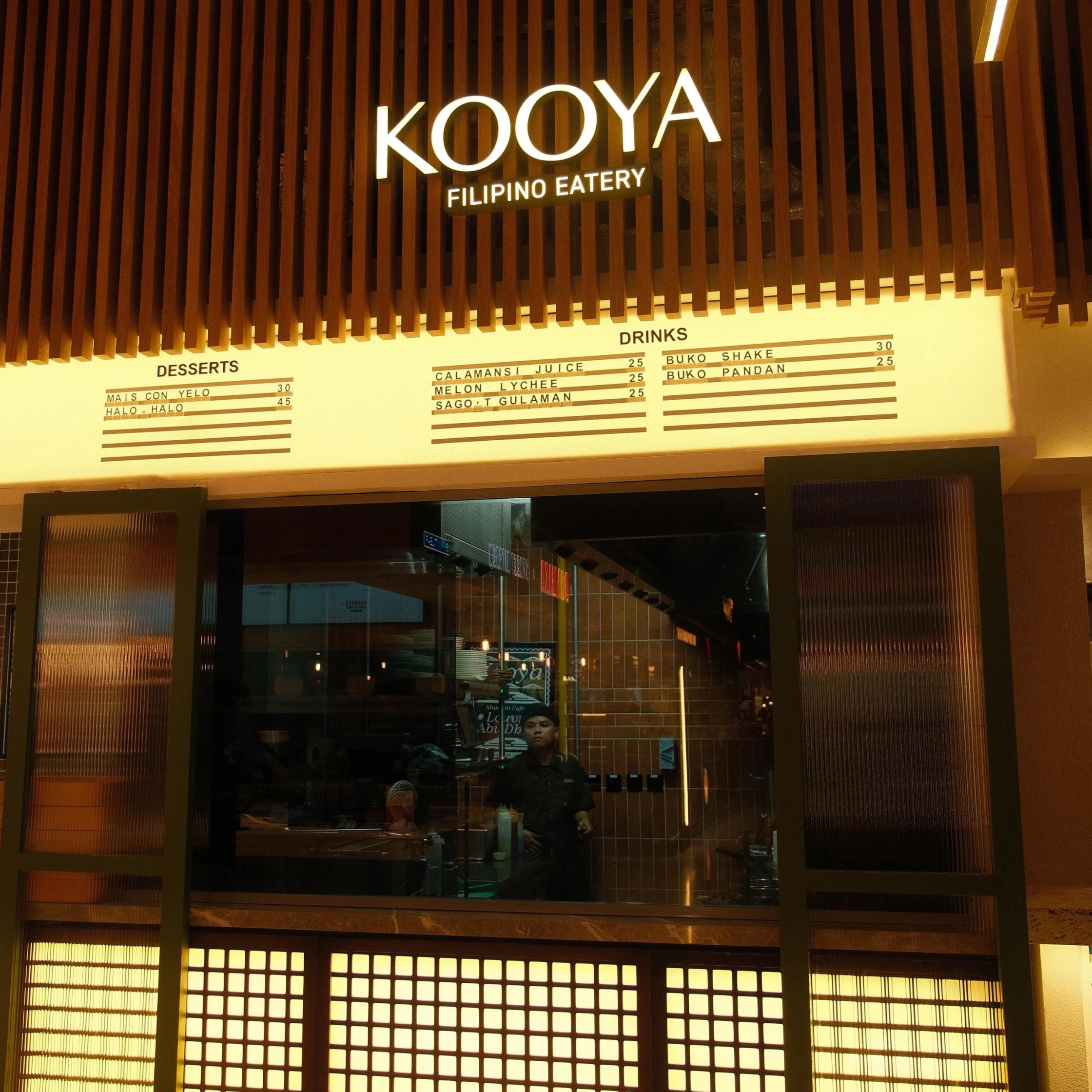 KOYA Filipino Eatery sign over a wood slat facade with a menu board listing drinks and desserts.