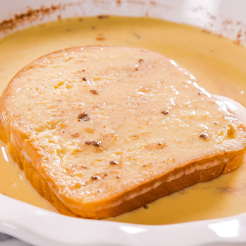 slice of brioche submerged in french toast mixture