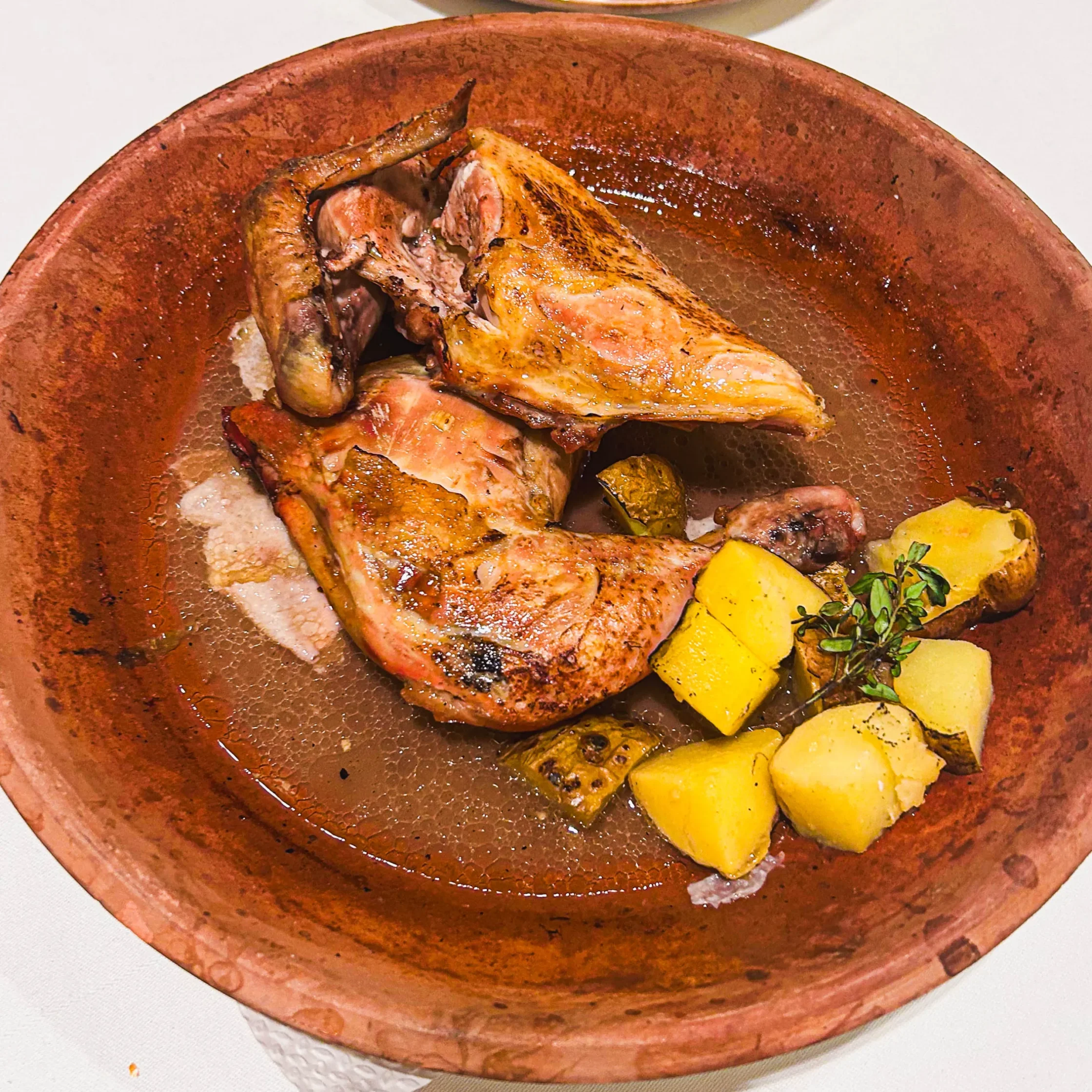 Spanish roast chicken at Asador de Aranda Manila with crispy skin served on a traditional clay platter