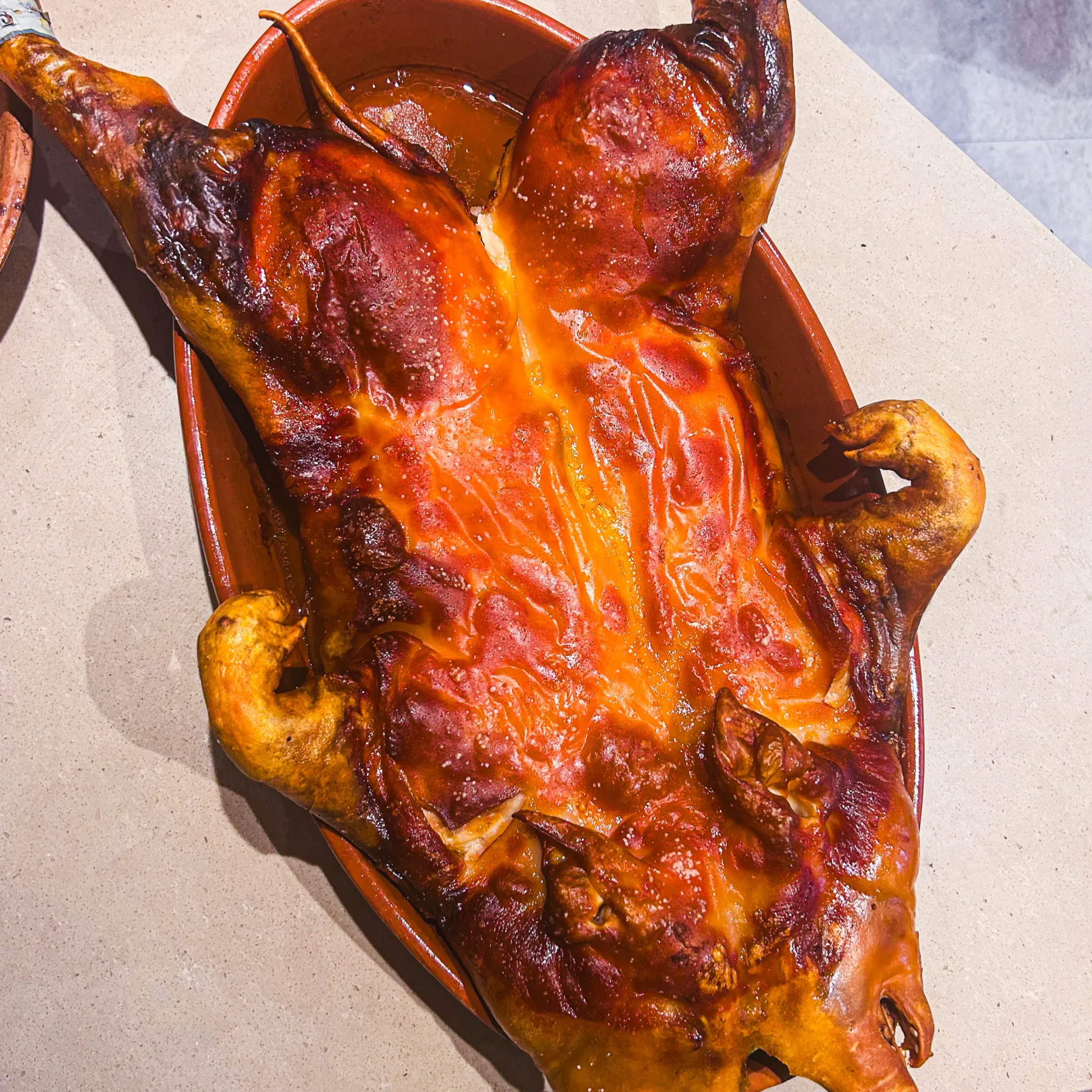 Whole roasted cochinillo at Asador de Aranda Manila with crispy golden skin, authentic Spanish suckling pig specialty