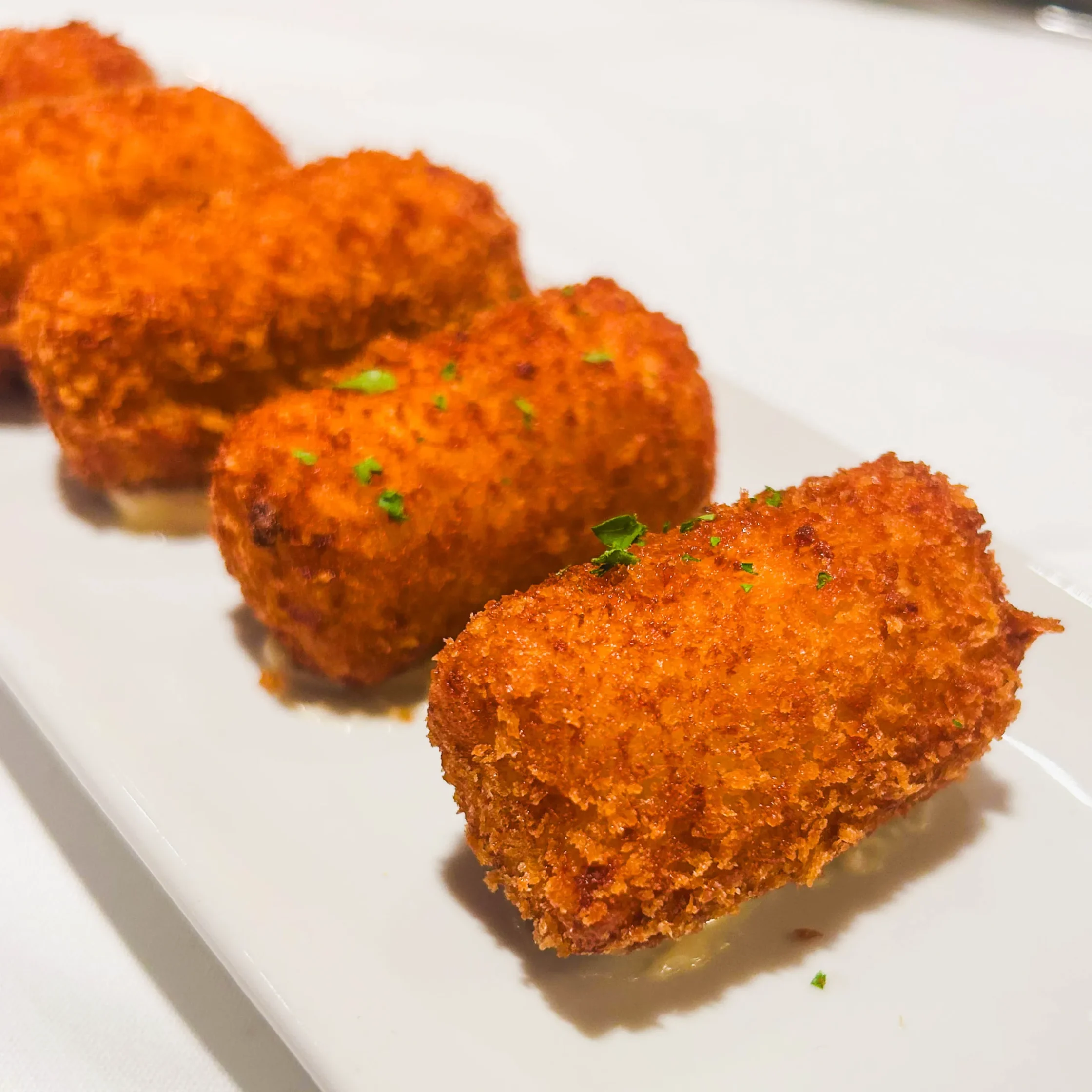 Crispy Spanish croquettes at Asador de Aranda Manila served golden brown with creamy filling and fresh herbs