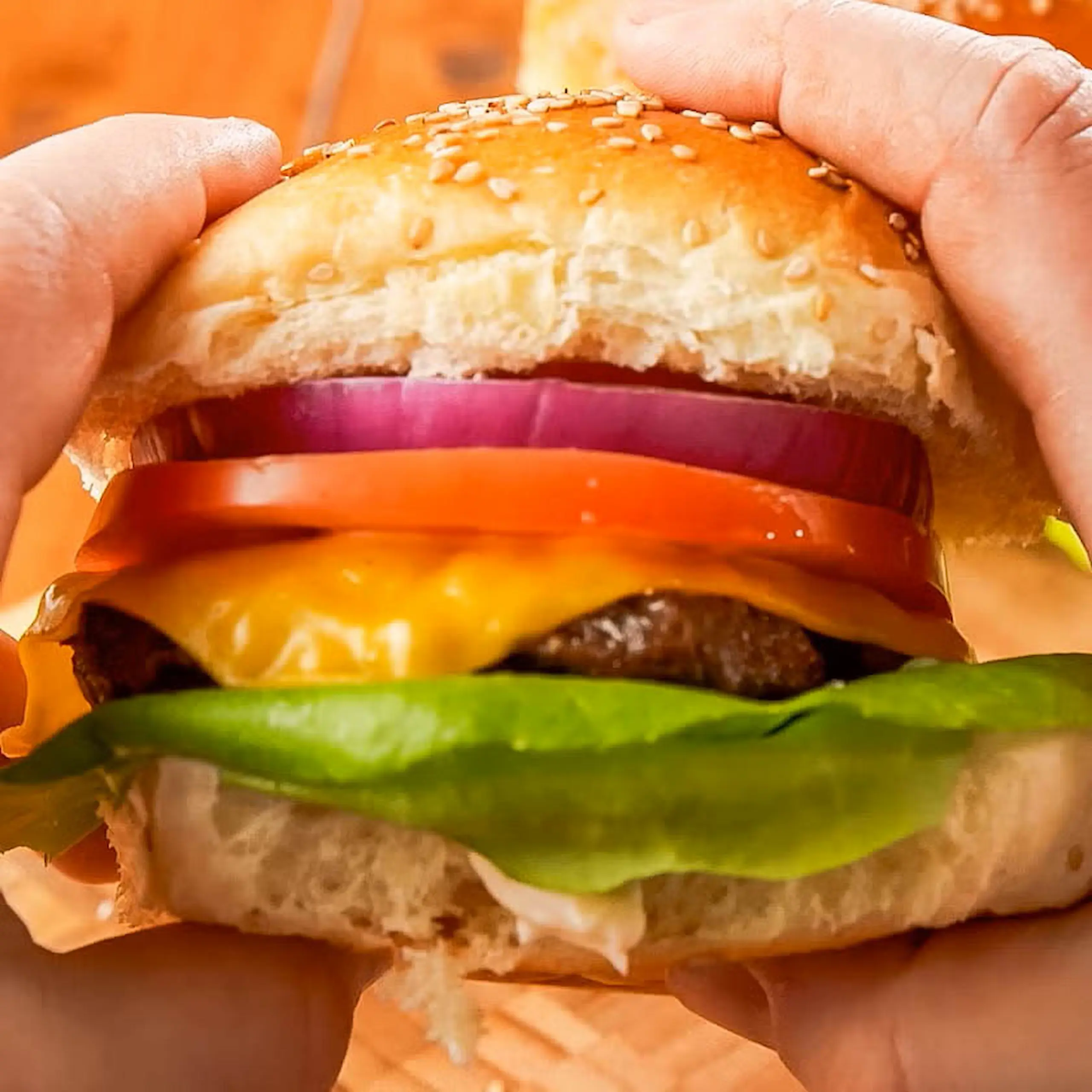 air-fried cheeseburger in hand