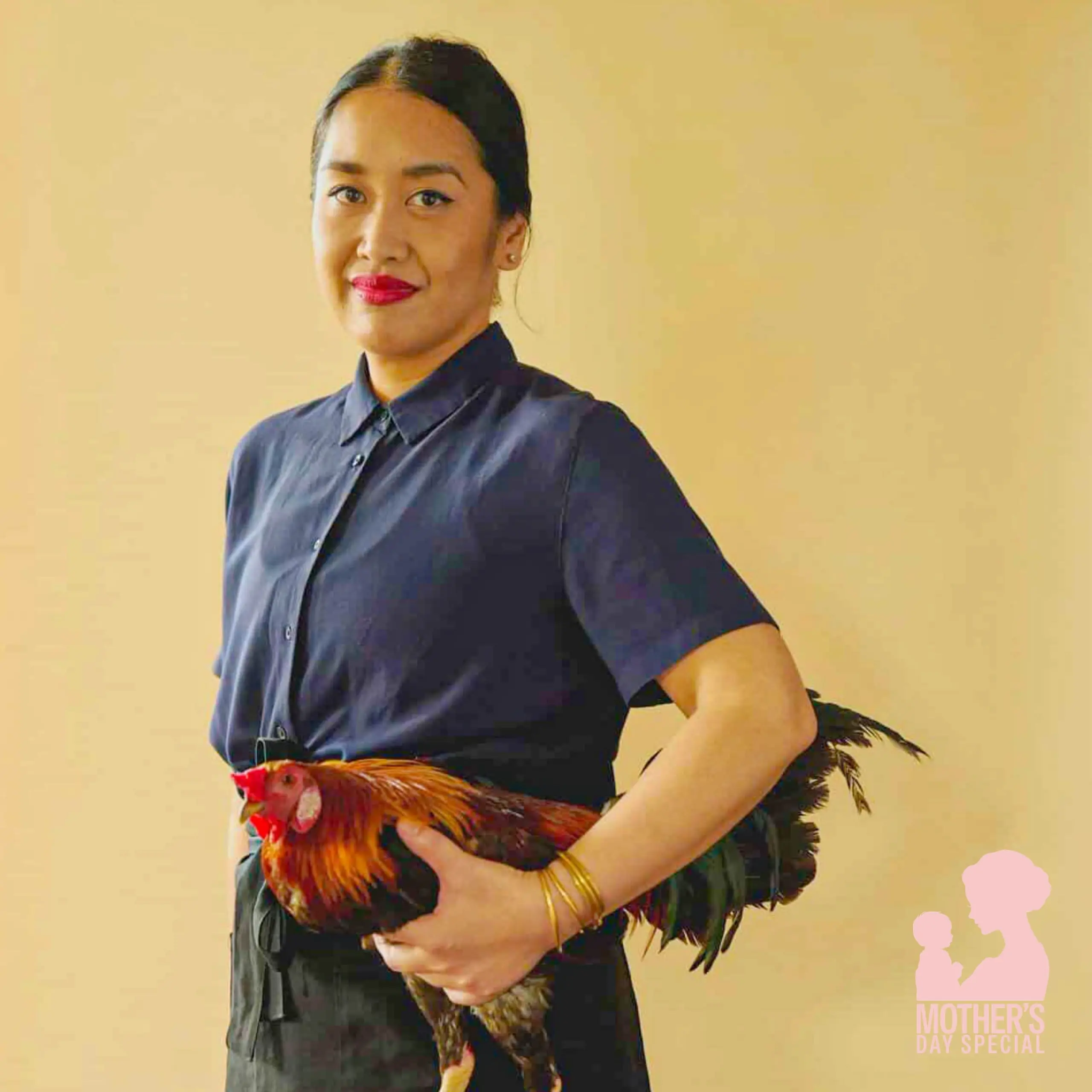 Woman in a dark shirt holding a colorful chicken against a beige background with a pink 'Mother's Day Special' watermark in the corner.