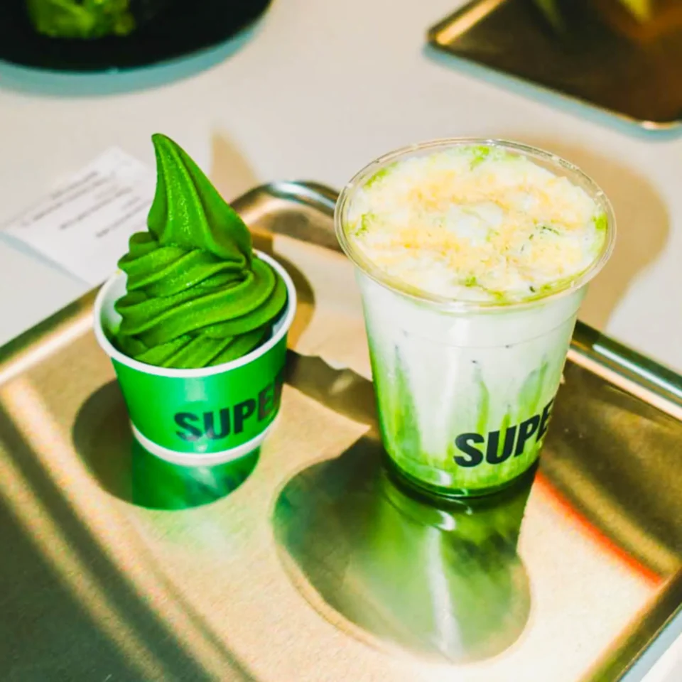 Matcha soft serve ice cream and creamy Ensaymatcha drink served together on a tray at Super Matcha café.