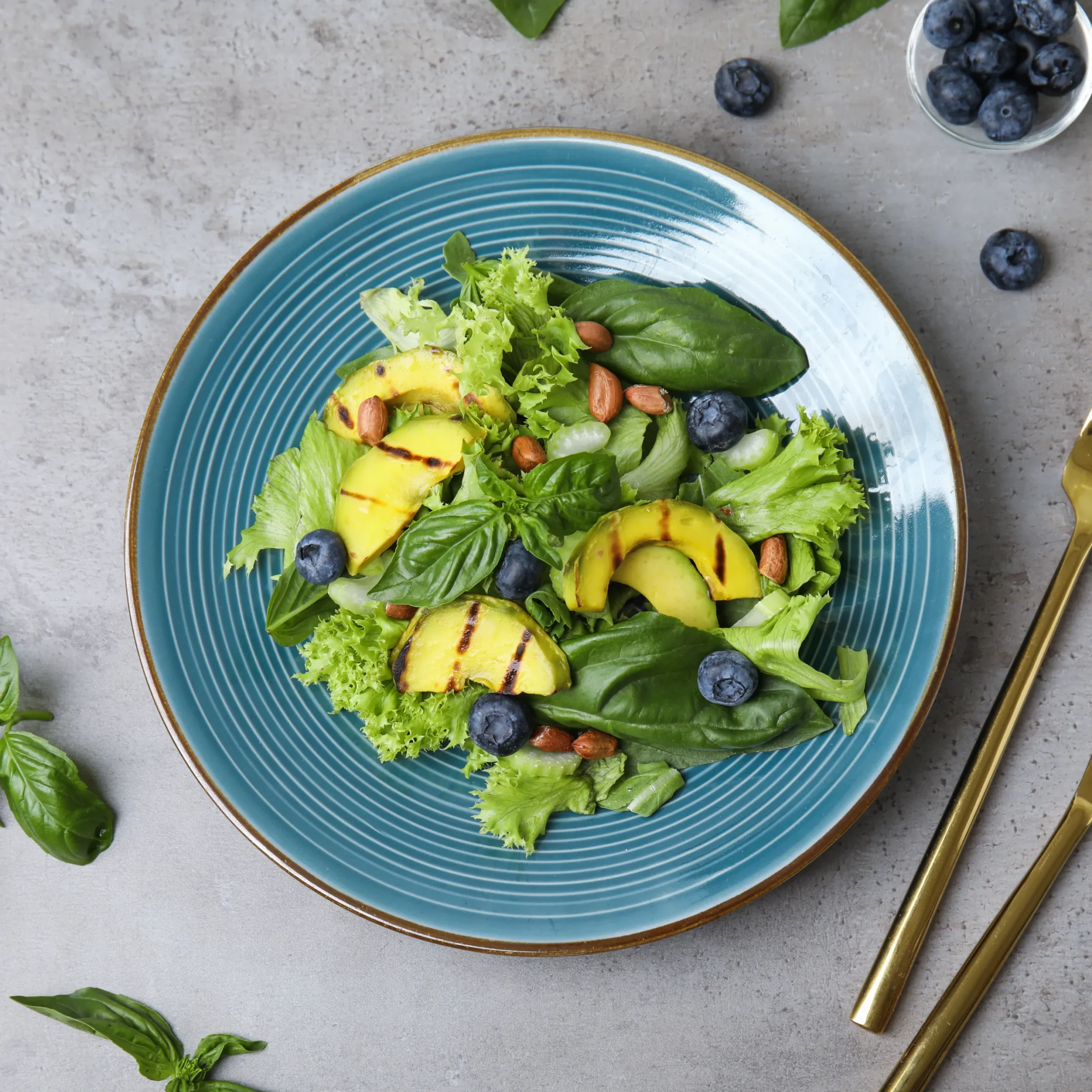 Set of brightly colored salad and dessert plates with concentric ring patterns, displayed on a light blue background to illustrate smaller plate options for appetizers, salads, and desserts.