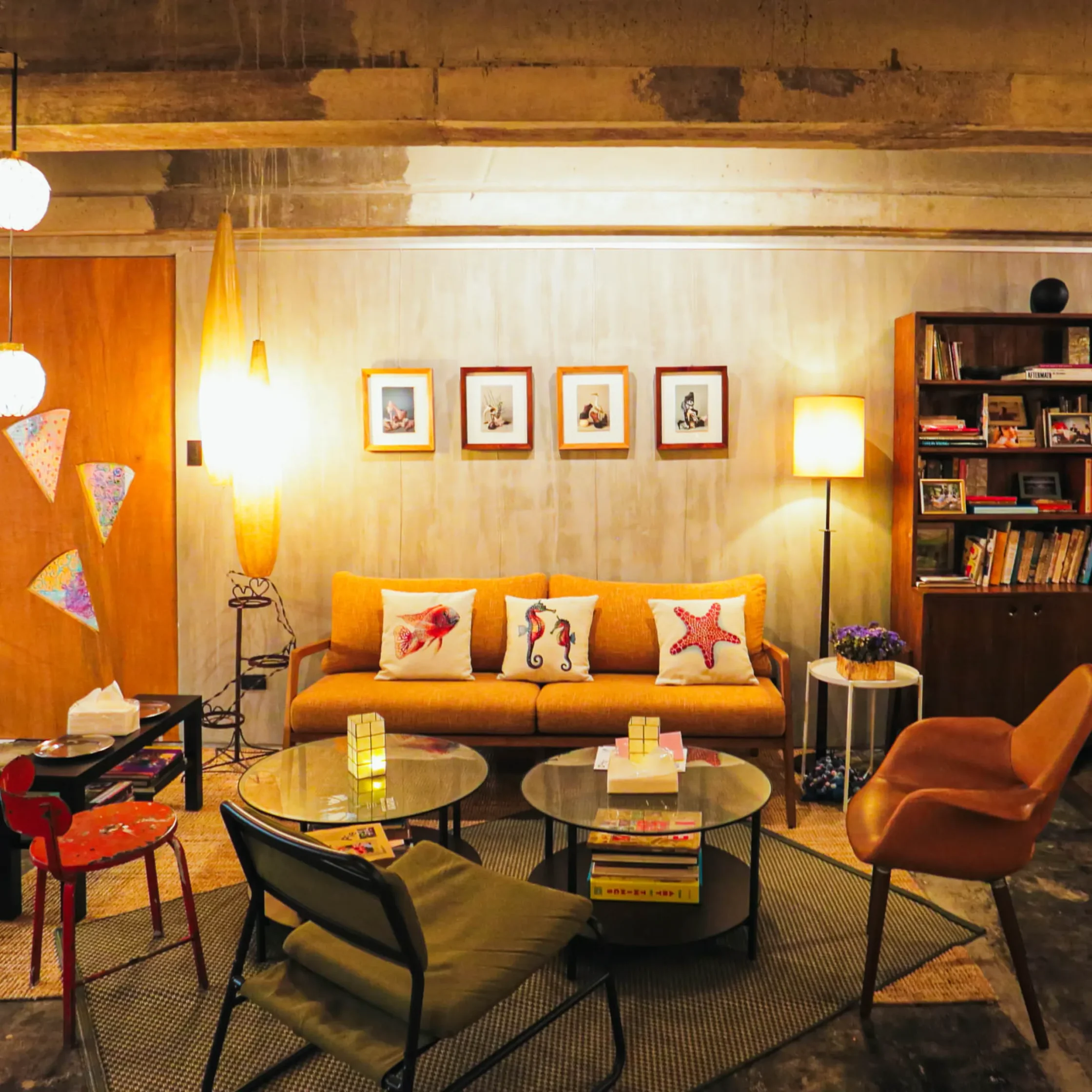 Cozy lounge and seating area inside Cutie Pie Pizza Karrivin Makati featuring modern industrial interiors, curated decor, bookshelf, and relaxed café-style atmosphere in Makati City