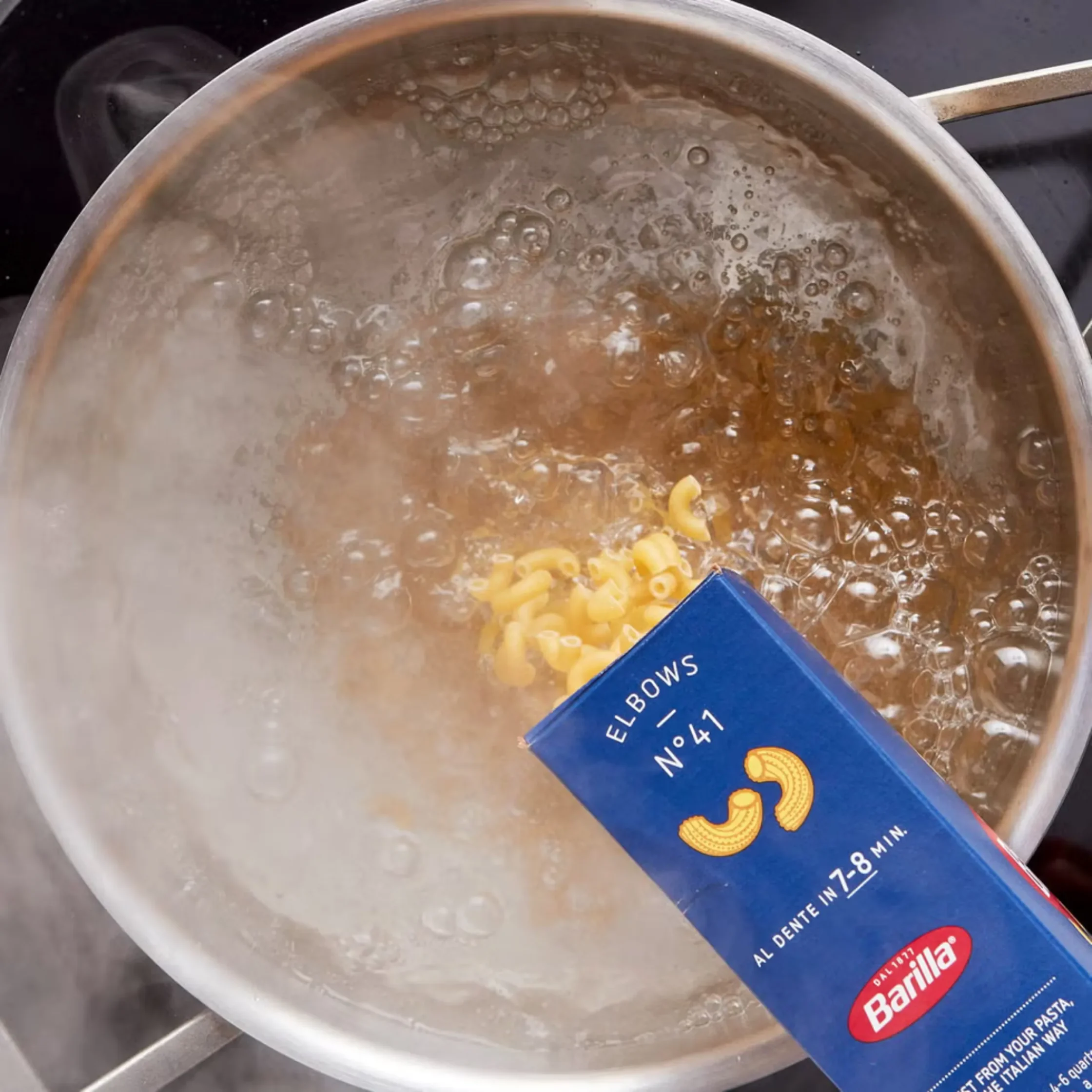 elbow pasta thrown in boiling water for mac and cheese