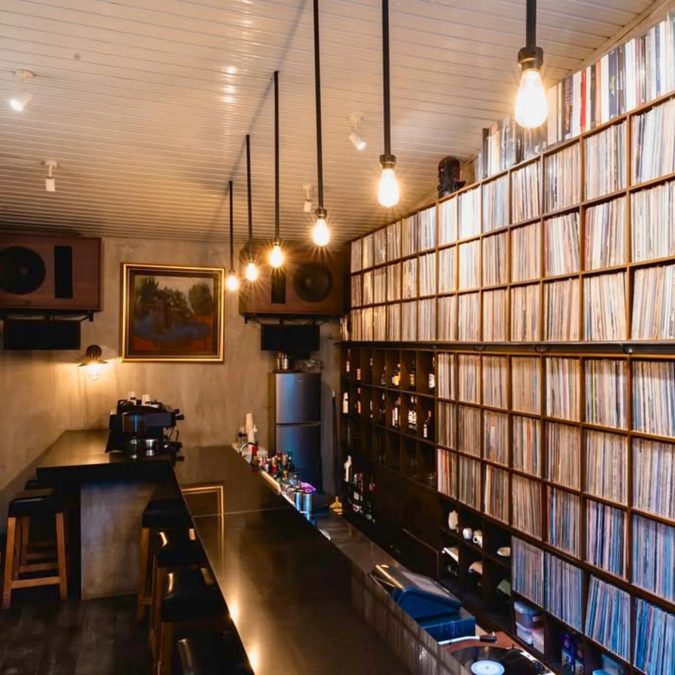 Vinyl-lined interior of 78-53-86 listening bar showcasing its jazz record collection and hi-fi sound system.