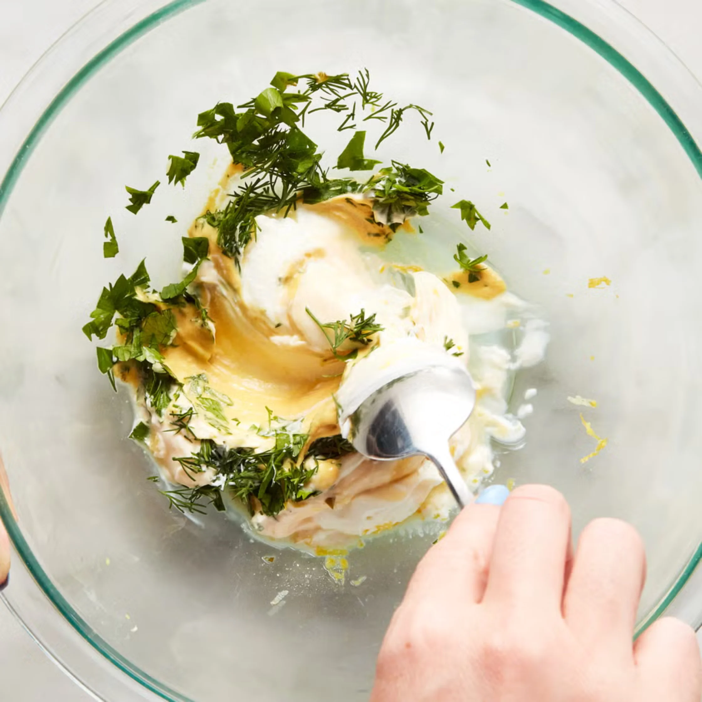 yogurt, mayonnaise, parsley, dill, mustard, lemon zest, and lemon juice in a bowl