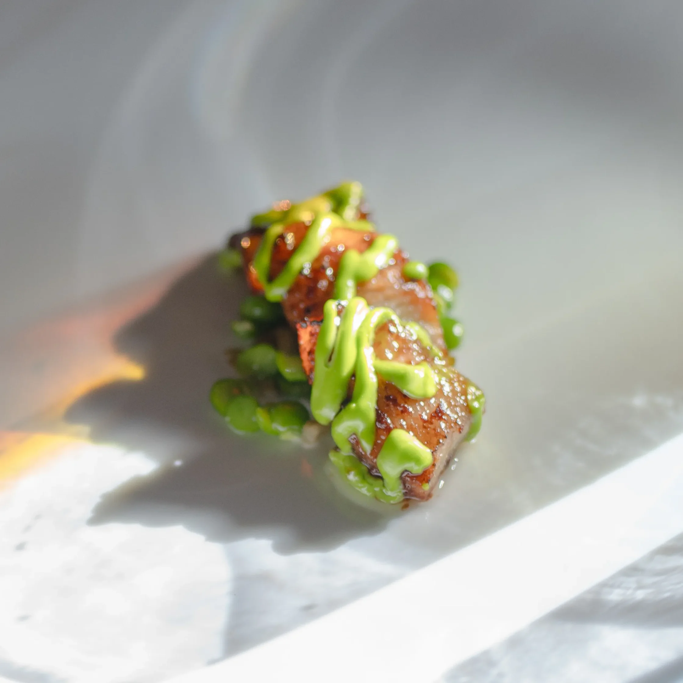 Perfectly caramelized Inihaw at Gulay from Chef Frances Tariga's Tadhana menu at the Mega Ball, finished with vibrant green accents.