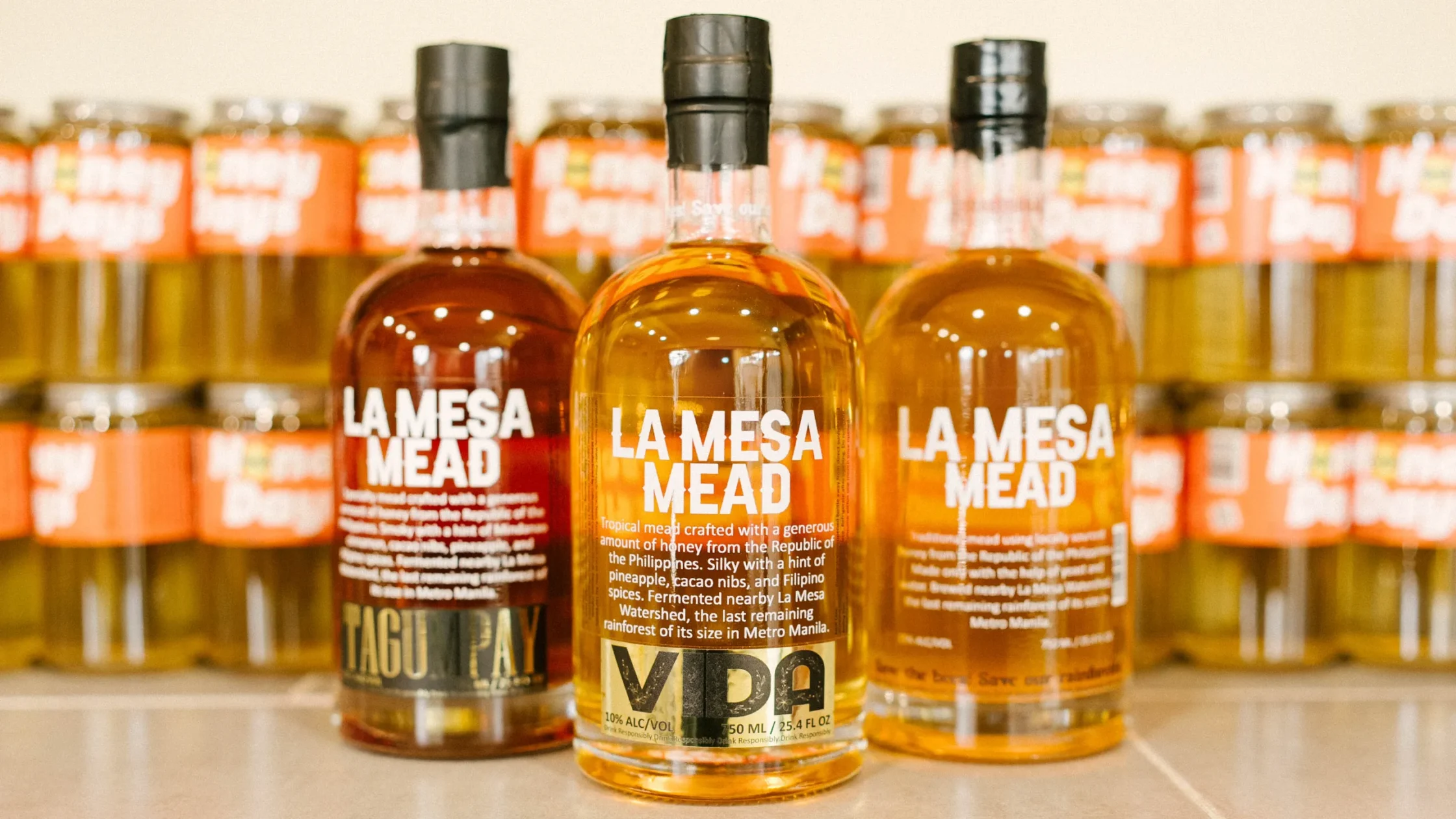 Assortment of LA MESA MEAD products, including Tagumpay and Vida varieties, arranged together with branded packaging visible.