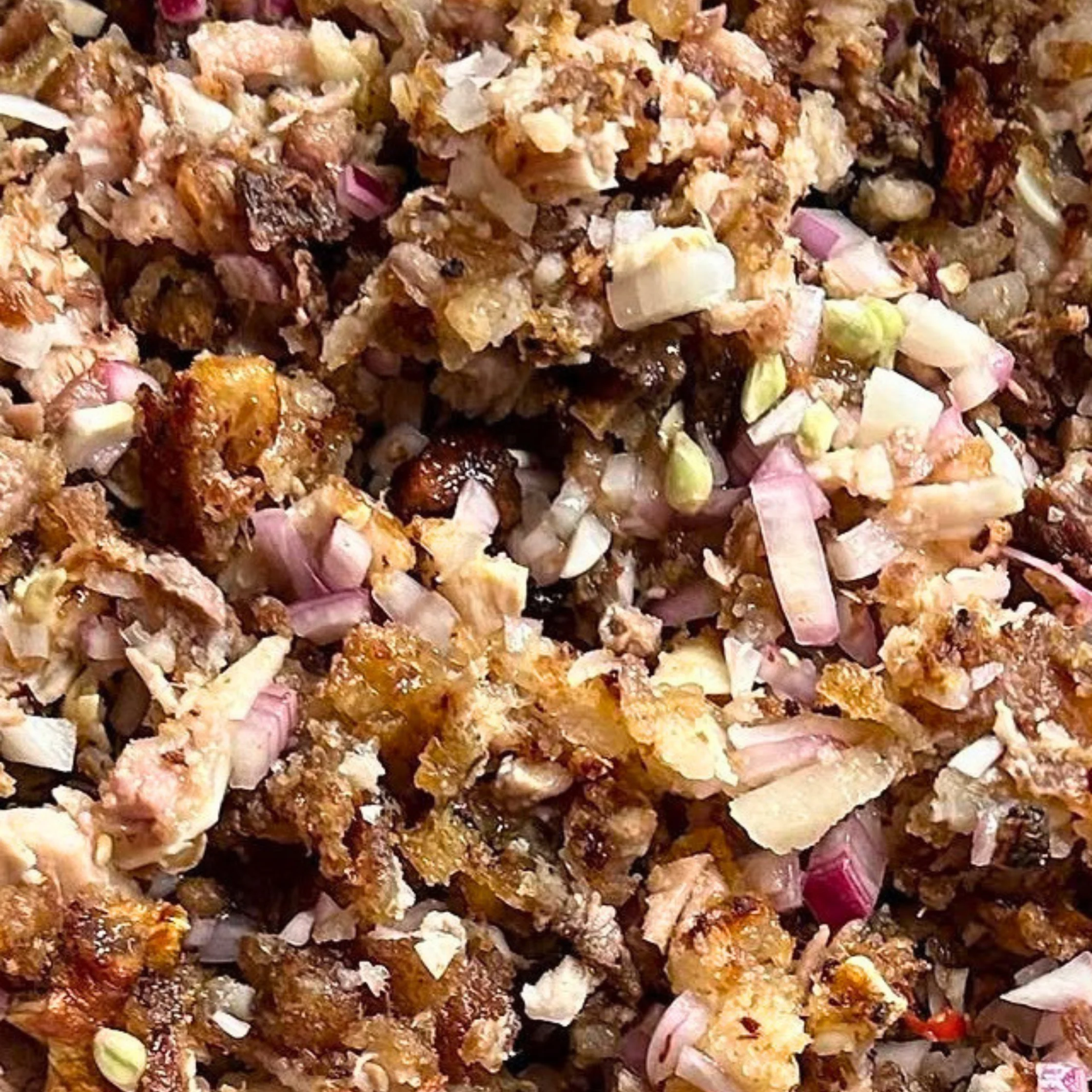 Sisig, one of Pampanga's most famous culinary contributions. It consists of chopped grilled or boiled pork parts (often face, ears, and jowl), mixed with onions and seasonings. Traditionally served sizzling, though it is often presented this way before plating.