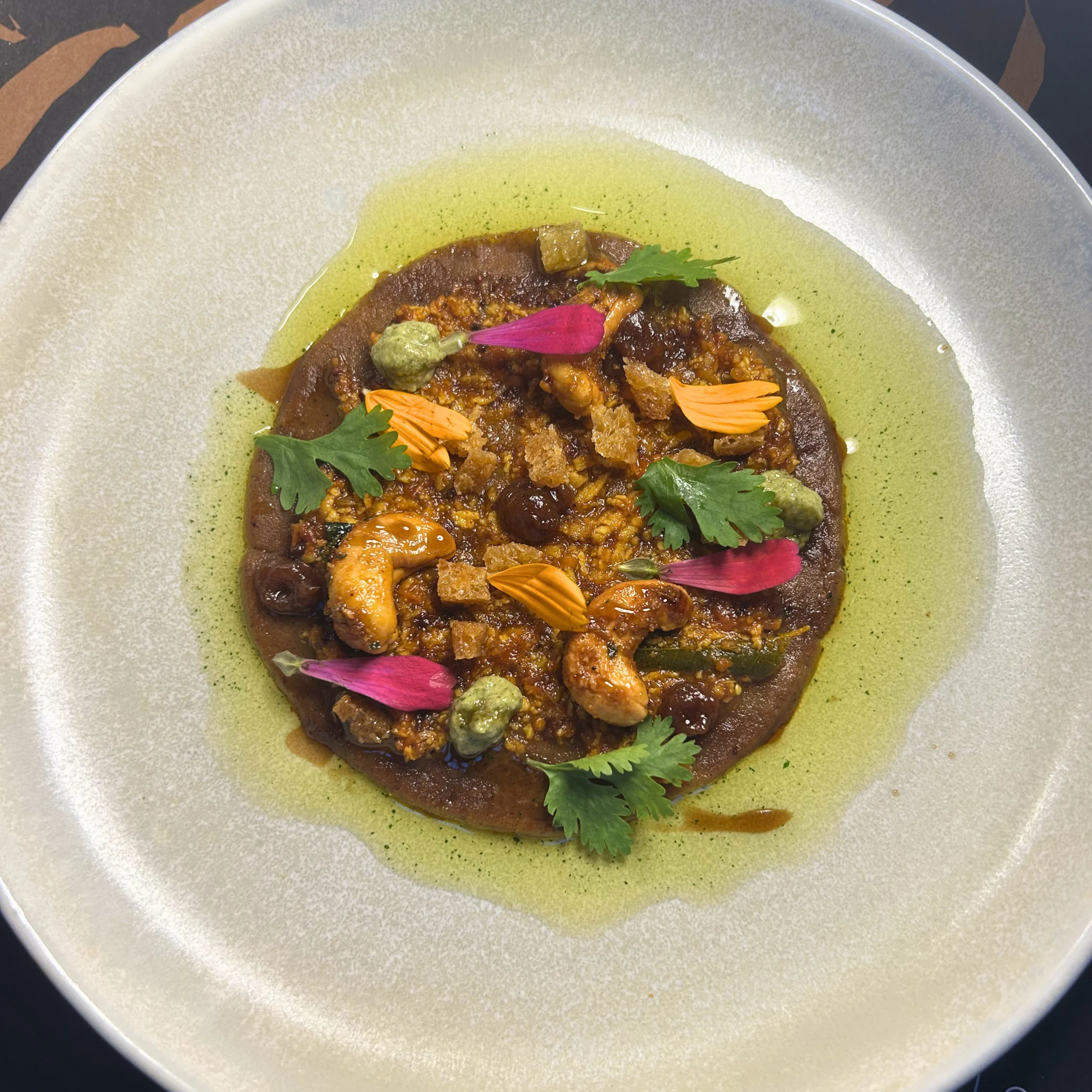 Dabeli masala potato stew is a vibrant, flavorful adaptation of Kutchi Dabeli, a famous Indian street food from Gujarat. It transforms the classic sweet, spicy, and tangy potato filling into a rich, comforting stew. The base is created by simmering mashed potatoes with dabeli masala, date-tamarind chutney, and aromatics, and then loading it with crunchy garnishes.