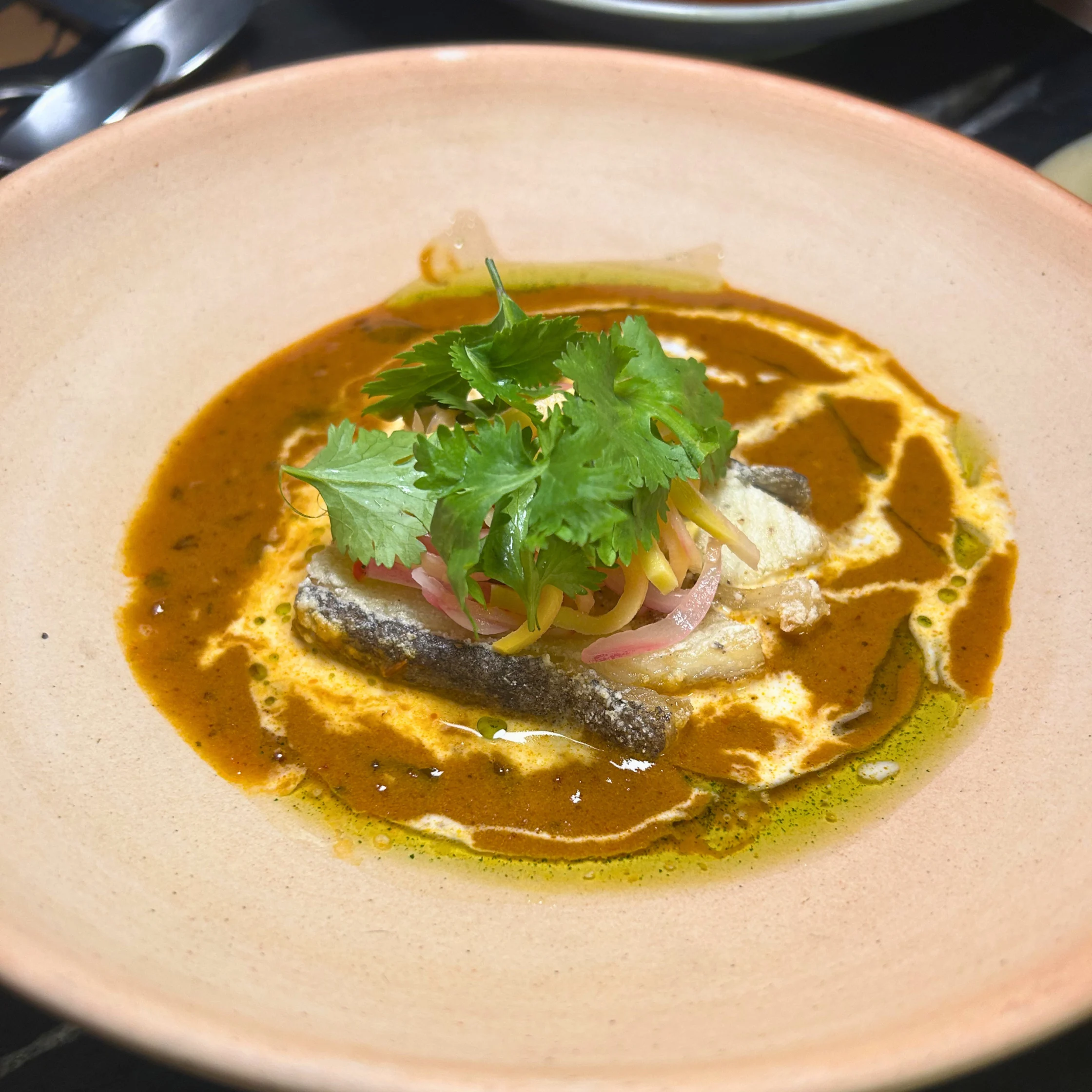 Goan Fish Curry is a vibrant, aromatic dish defined by its rich coconut sauce, fragrant spices, and a signature tangy kick, usually from tamarind or kokum. It is traditionally made with firm white fish or mackerel and served over steamed basmati or red rice.