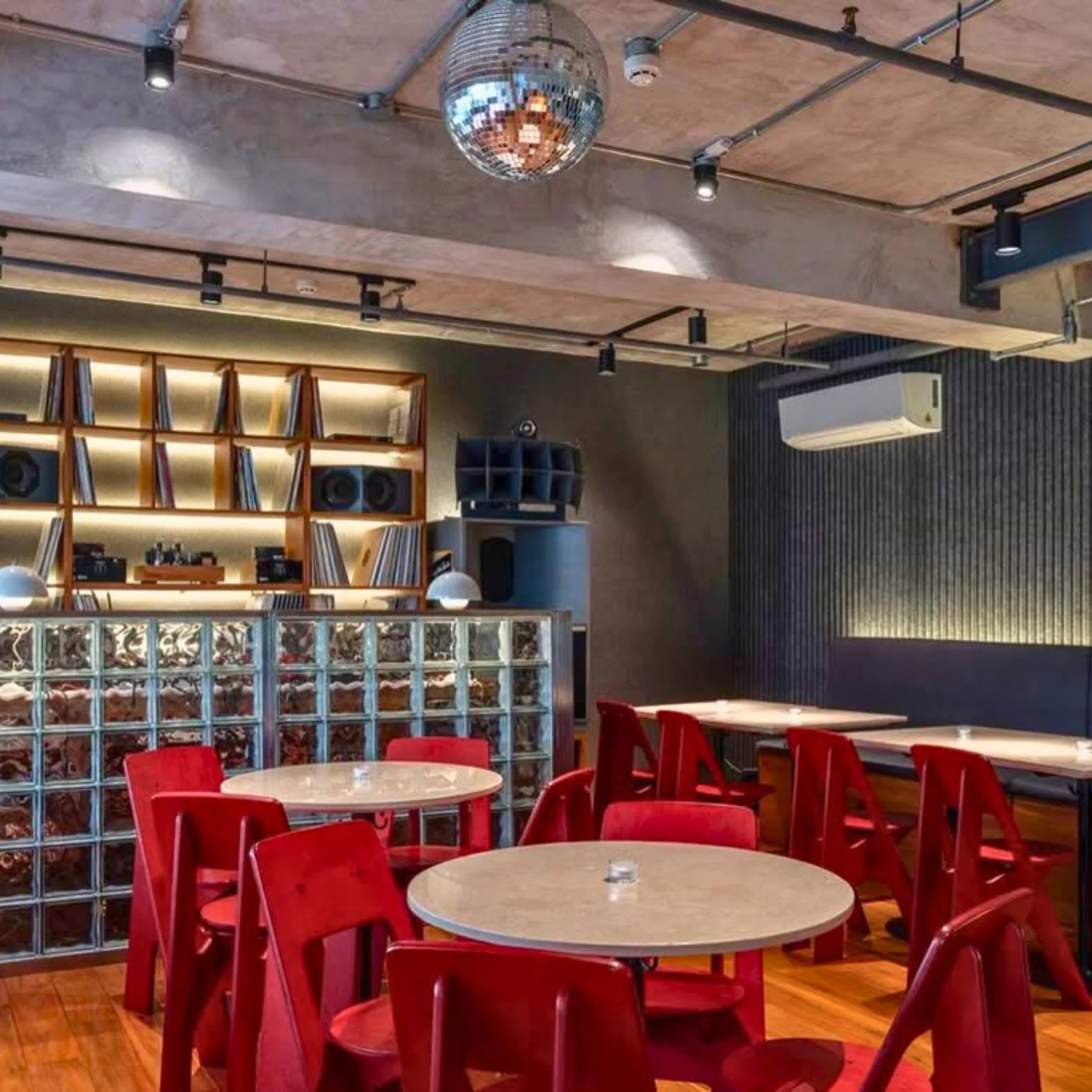 Interior of GotSoul MNL in BGC featuring dining tables, vinyl displays, and audiophile sound systems.