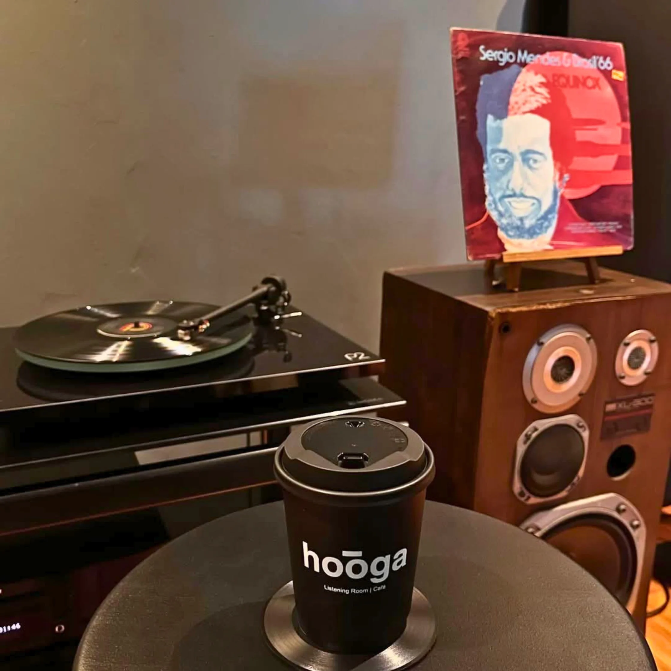 Turntable, speakers, and coffee setup inside Hooga Listening Room and Café.
