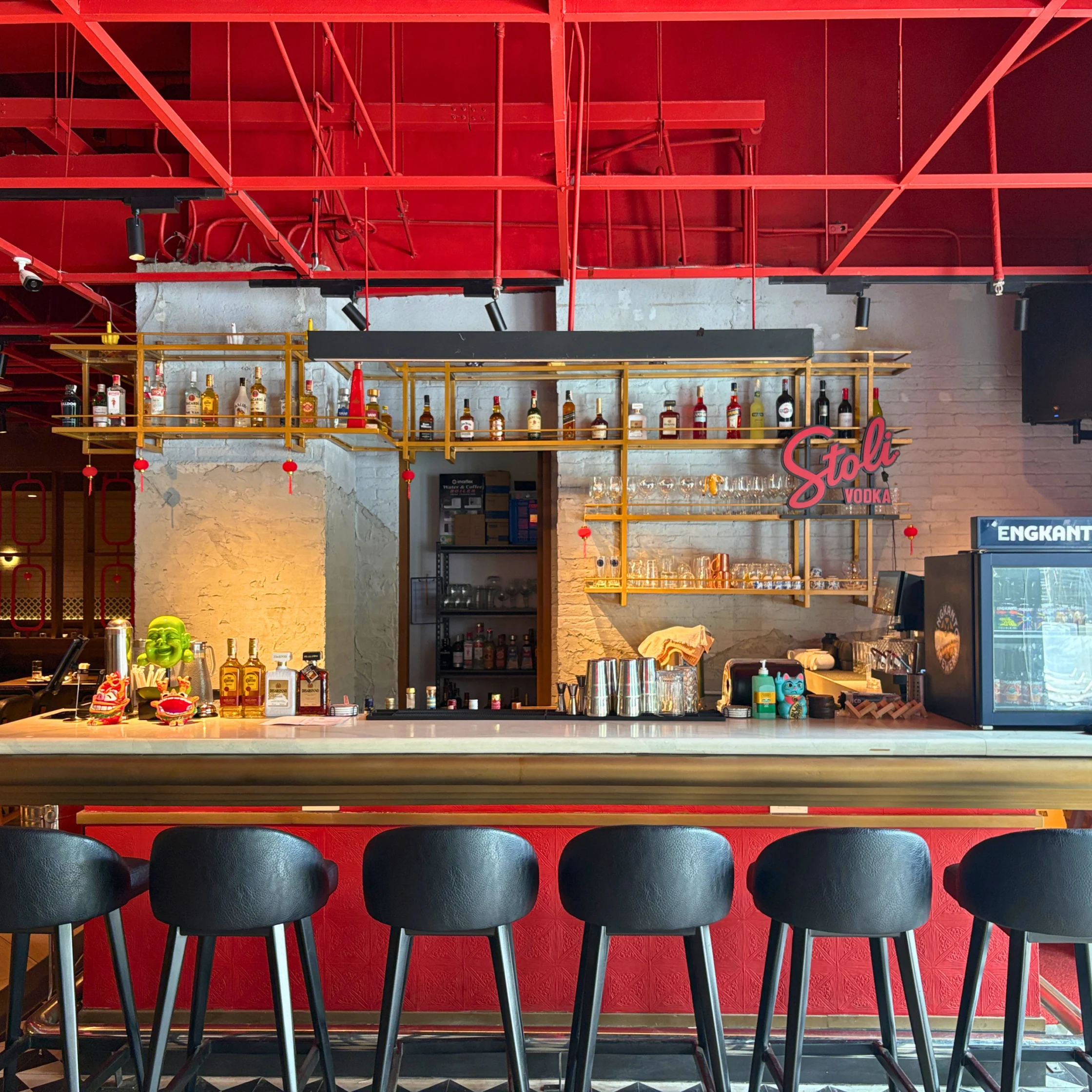 wong place capital commons pasig bar that's industrial with fun pops of color like red and green with warm lighting