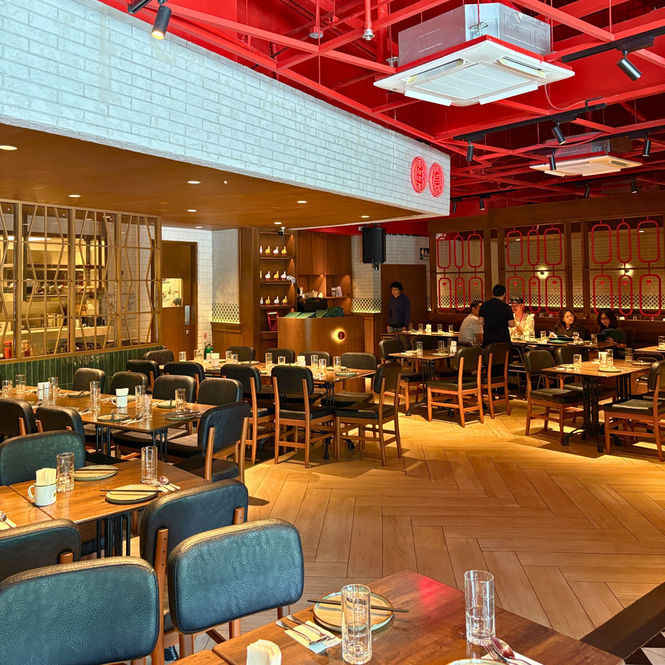 wong place capital commons pasig interior that's industrial with fun pops of color like red and green with warm lighting