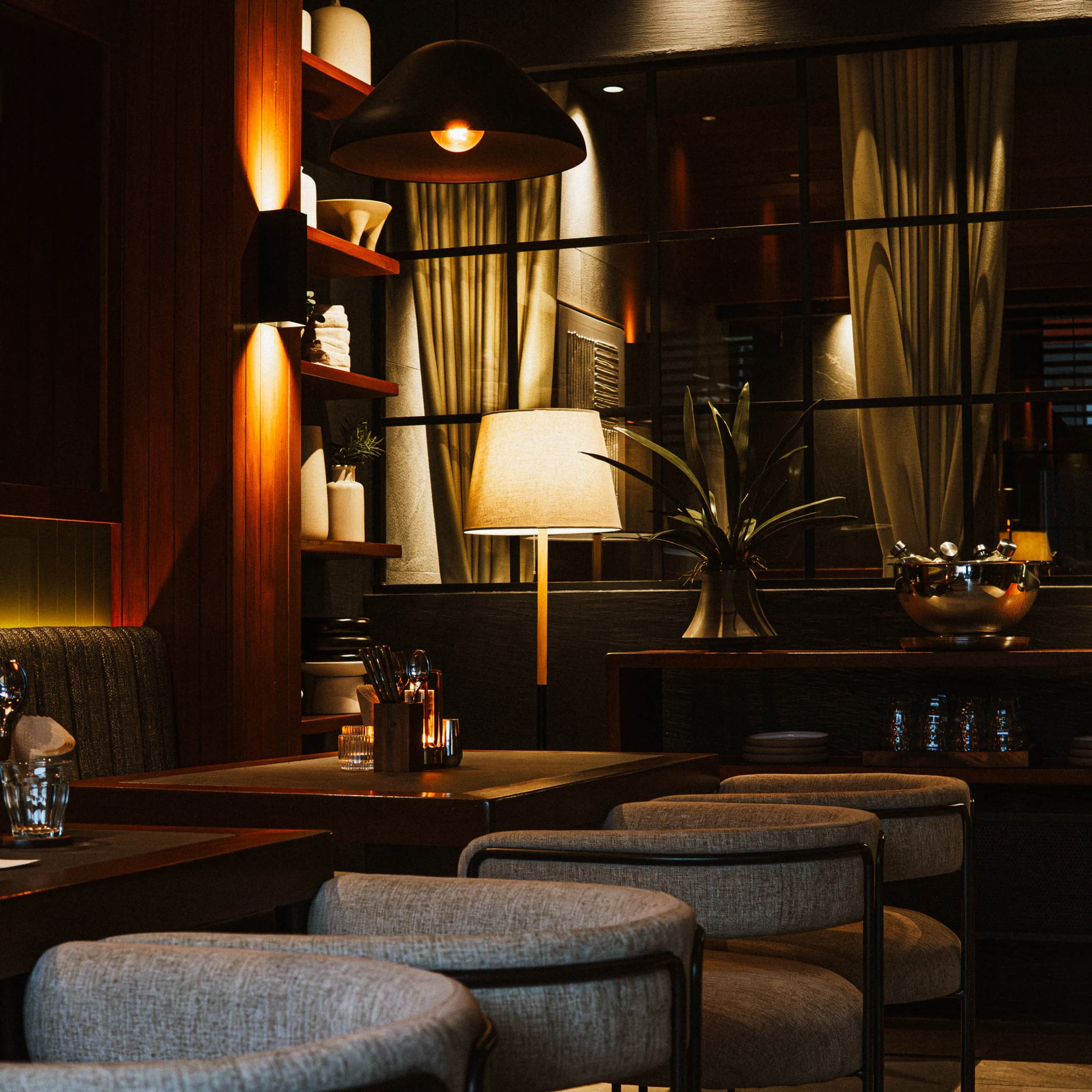 Restaurant interior with low warm lighting and velvet seats