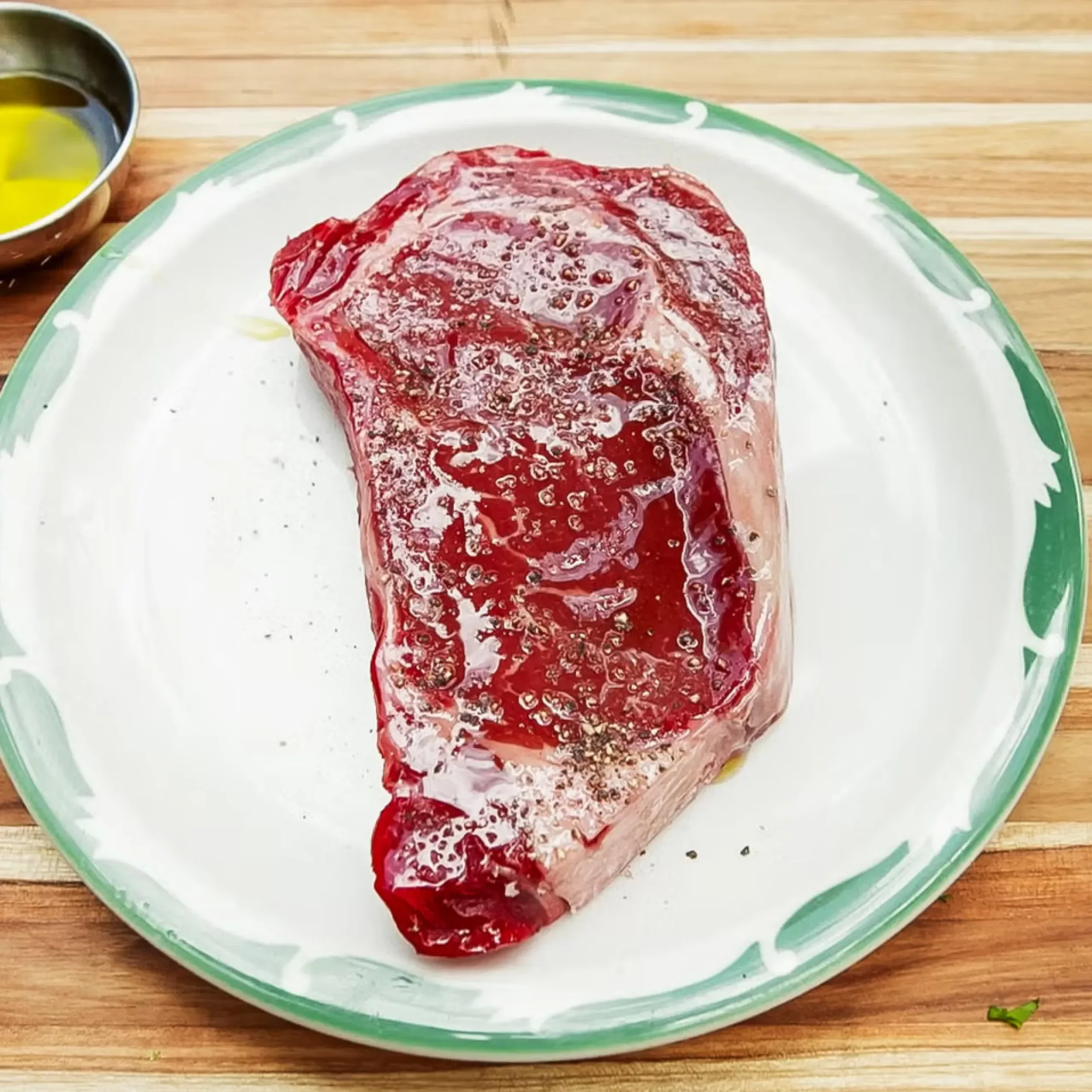 Seasoned steak before grilling