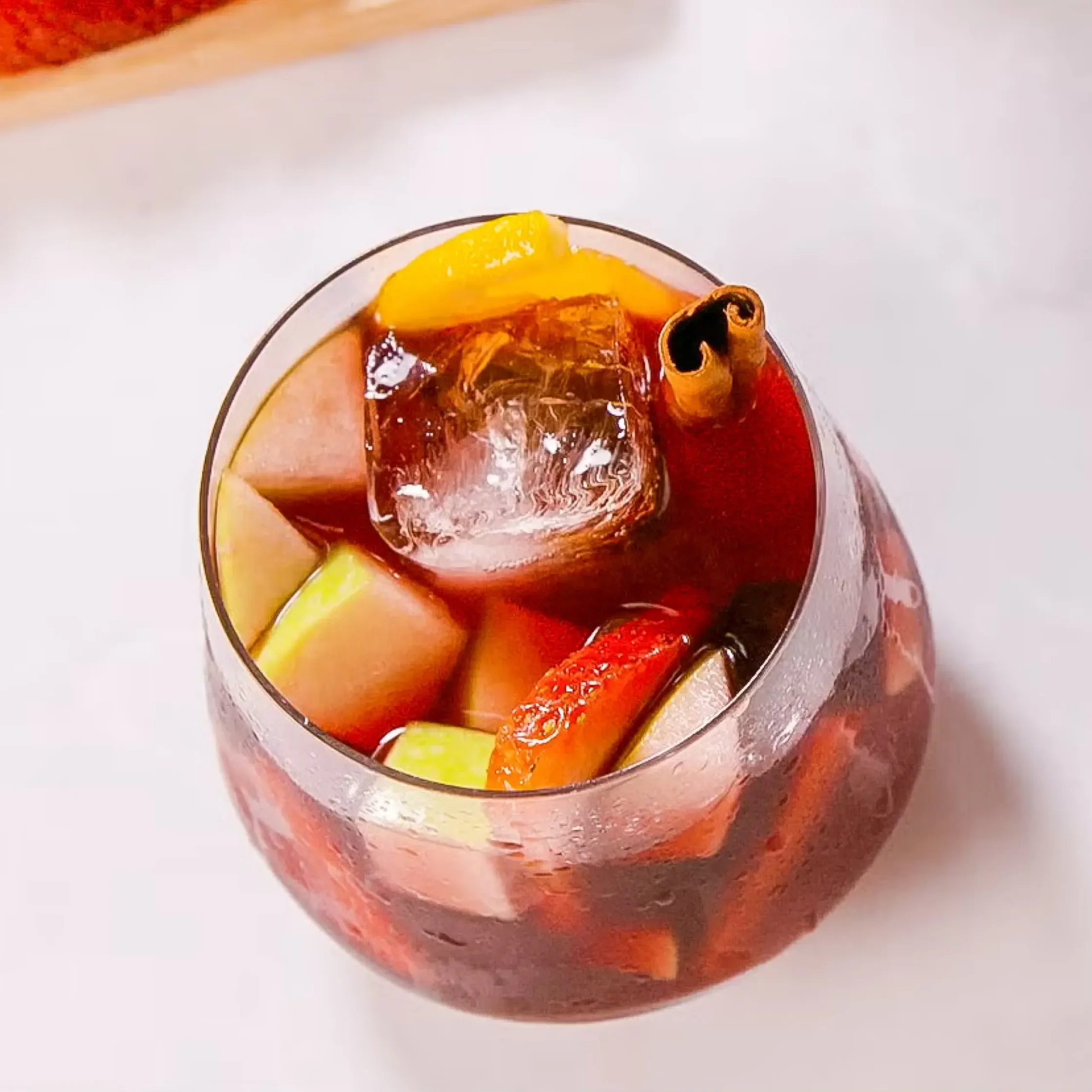 Serve over ice, with some of the fruit from the pitcher.