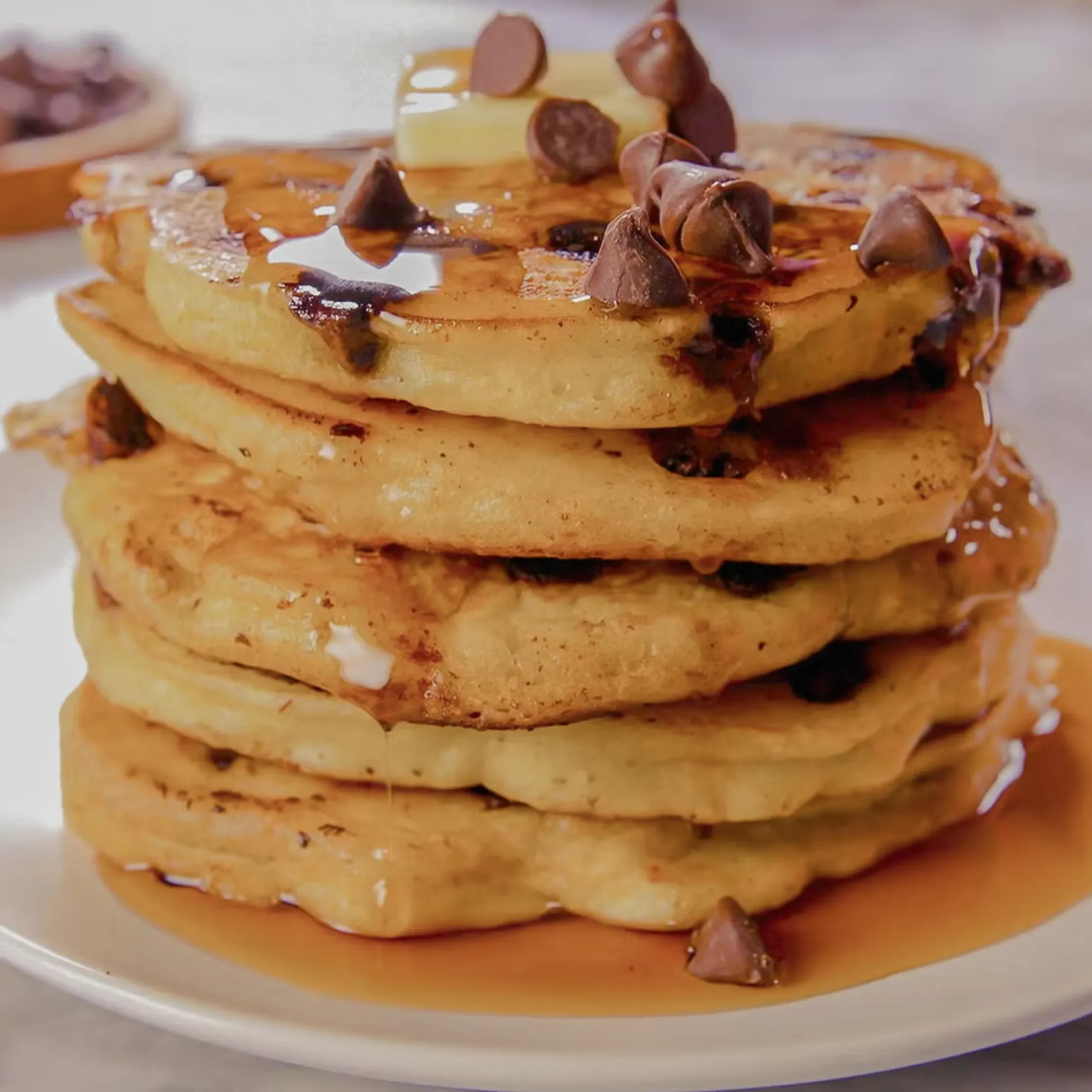Cooked pancakes with butter and maple syrup