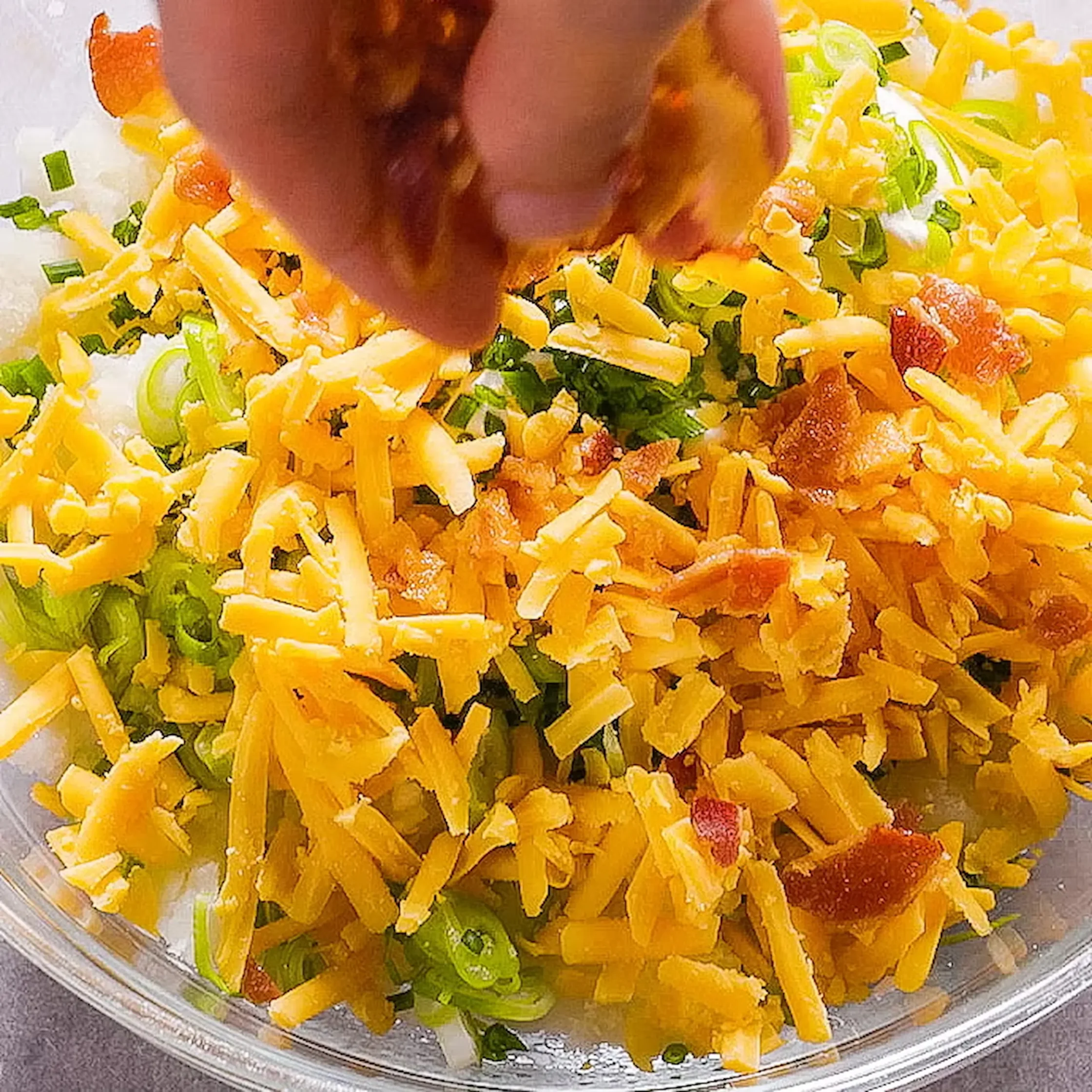 Sour cream, chives, white scallion parts (save the green parts for topping), and half of the cheddar and bacon