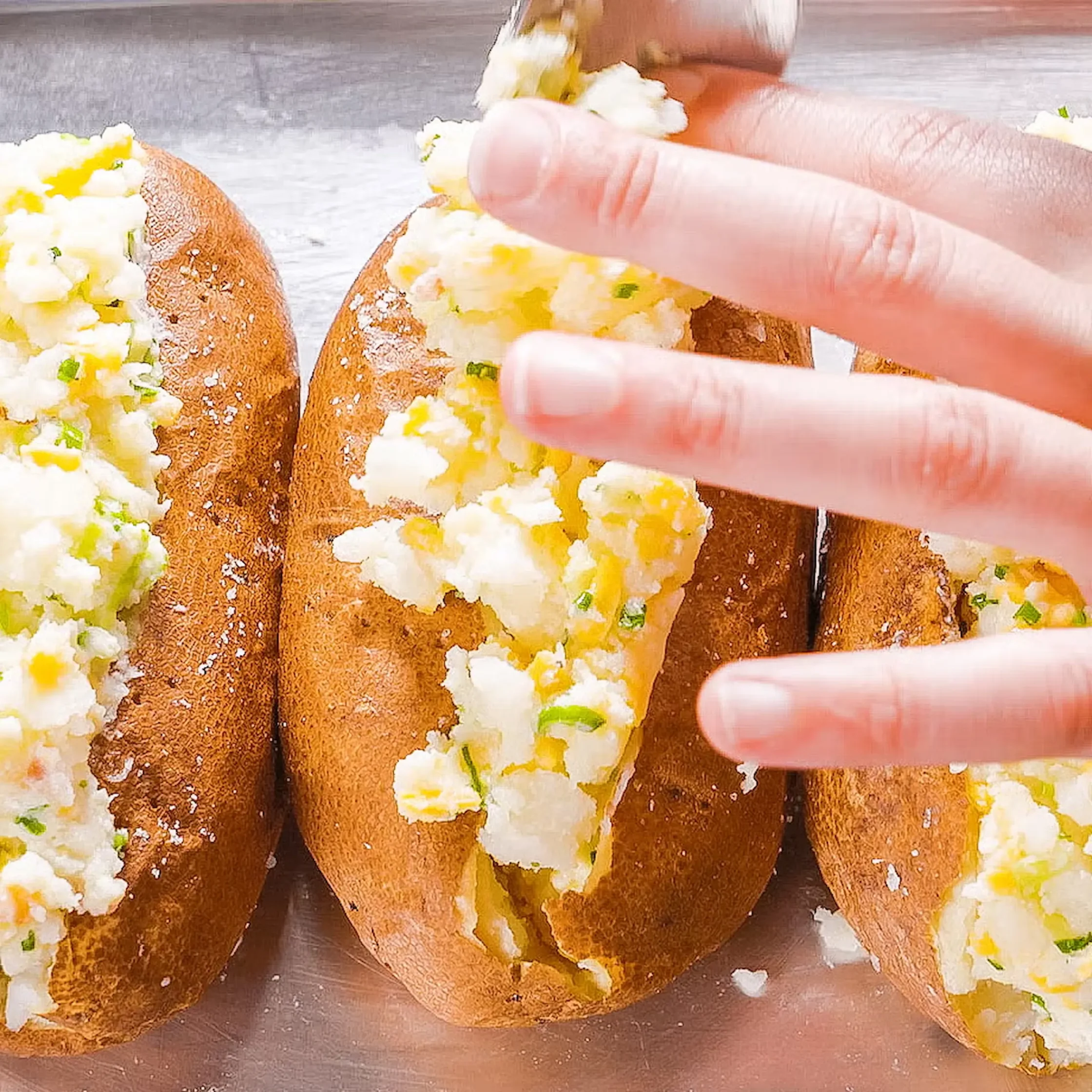 Spoon the filling back into the potatoes, mounding it on top—be generous but be gentle!