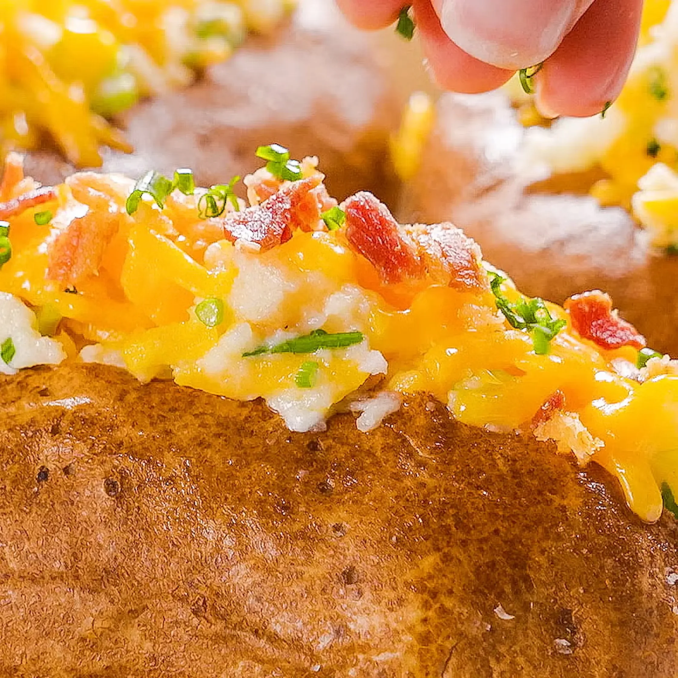 Finally, top the potatoes with some scallion greens and the rest of the bacon, and serve them up.