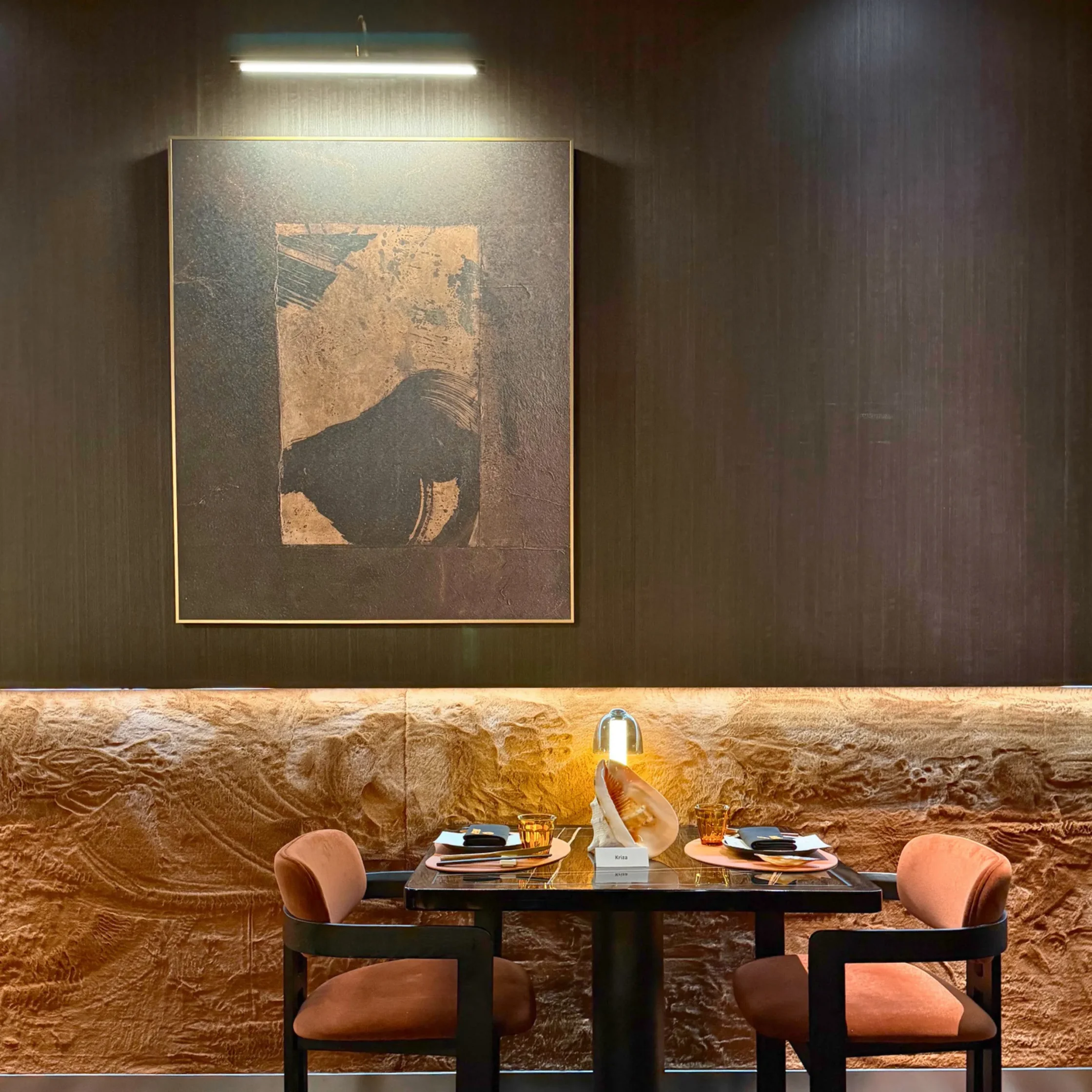 interior photo with frame on wall and table with two seats
