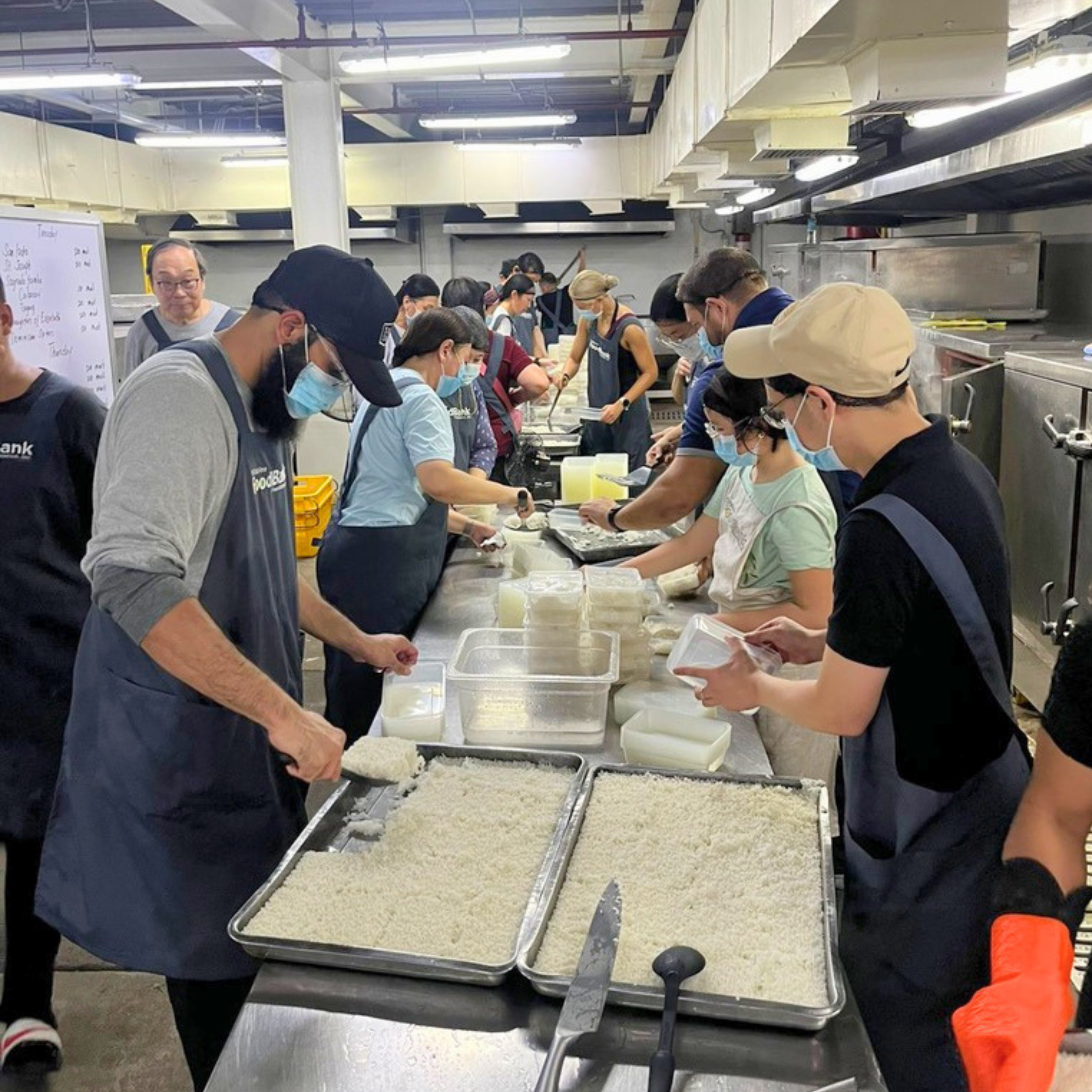 Volunteers portion cooked rice at the Philippine FoodBank Foundation, one of the organizations supported through Mabu's food rescue initiatives.