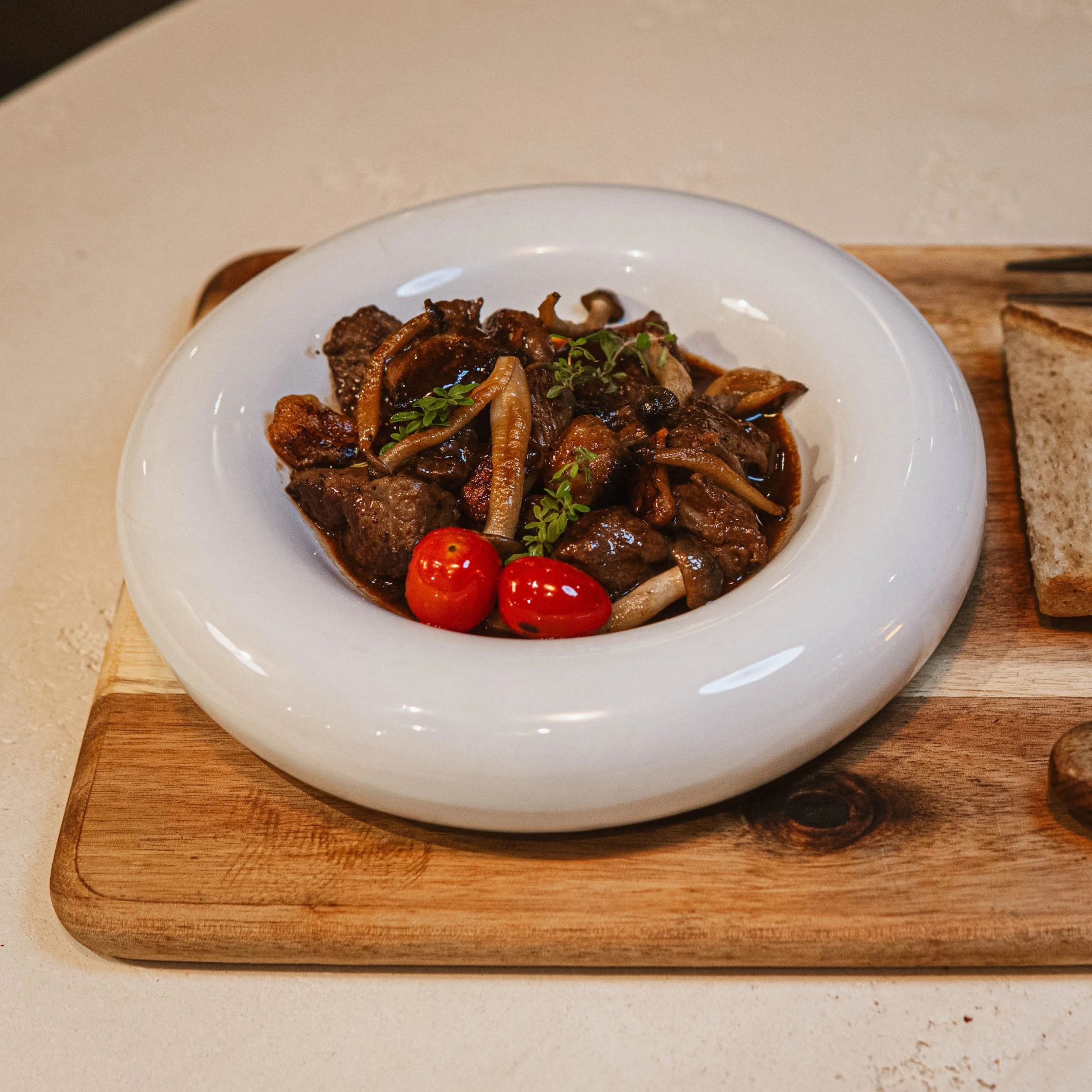 Salpicao beef in a round white plate