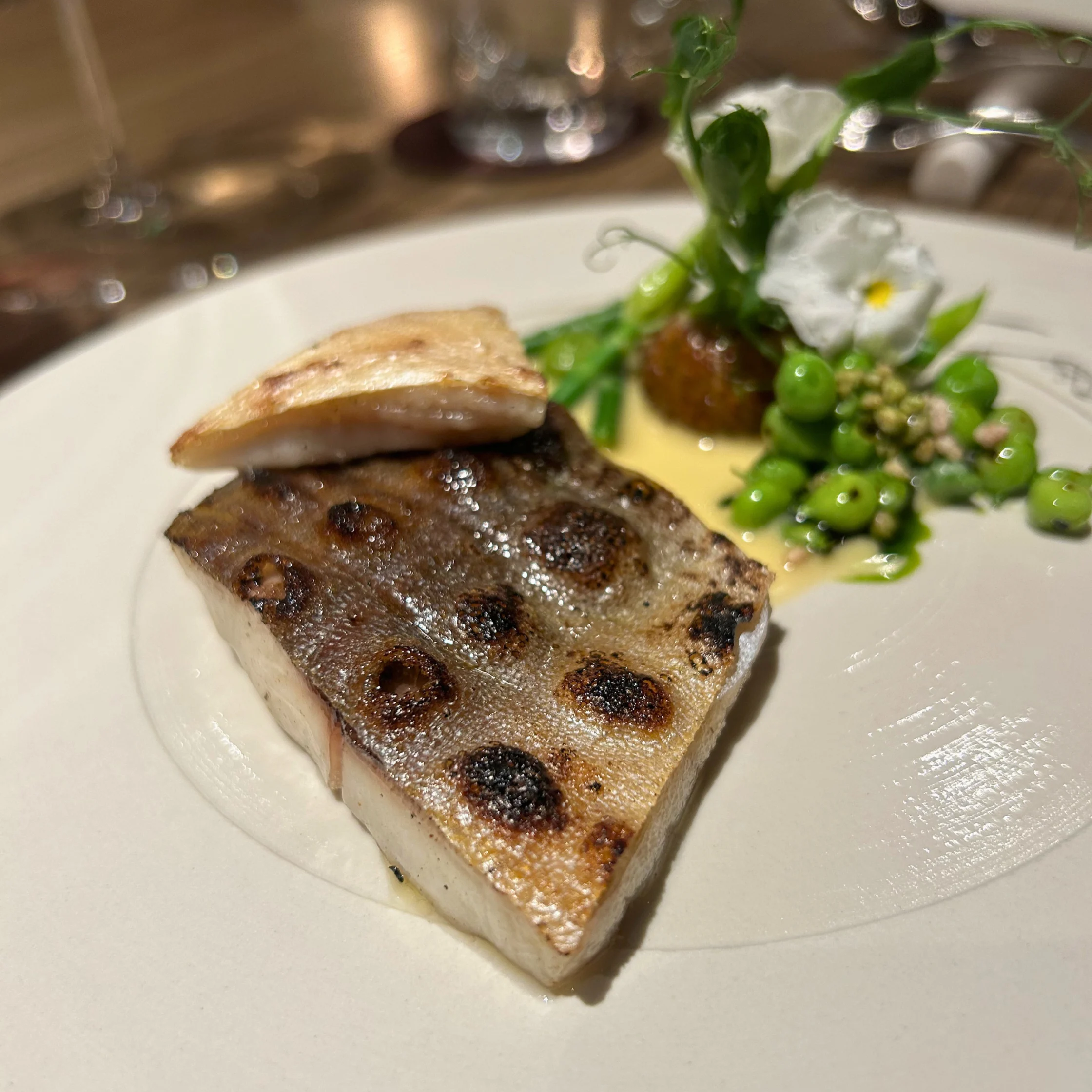 aged pomfret with bbq sweet peas and a lime leaf butter sauce