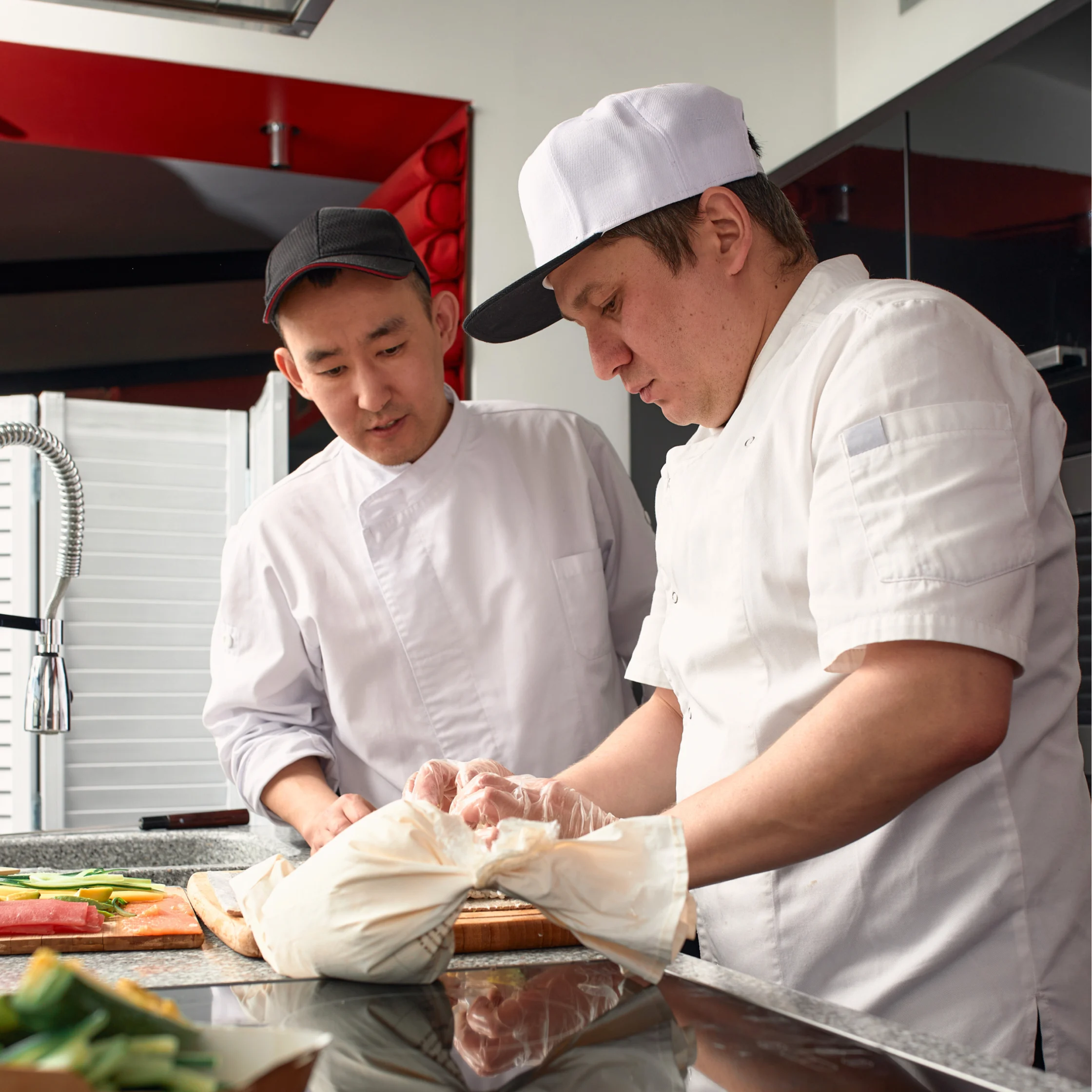 two chef collaborating on food inside kitchen