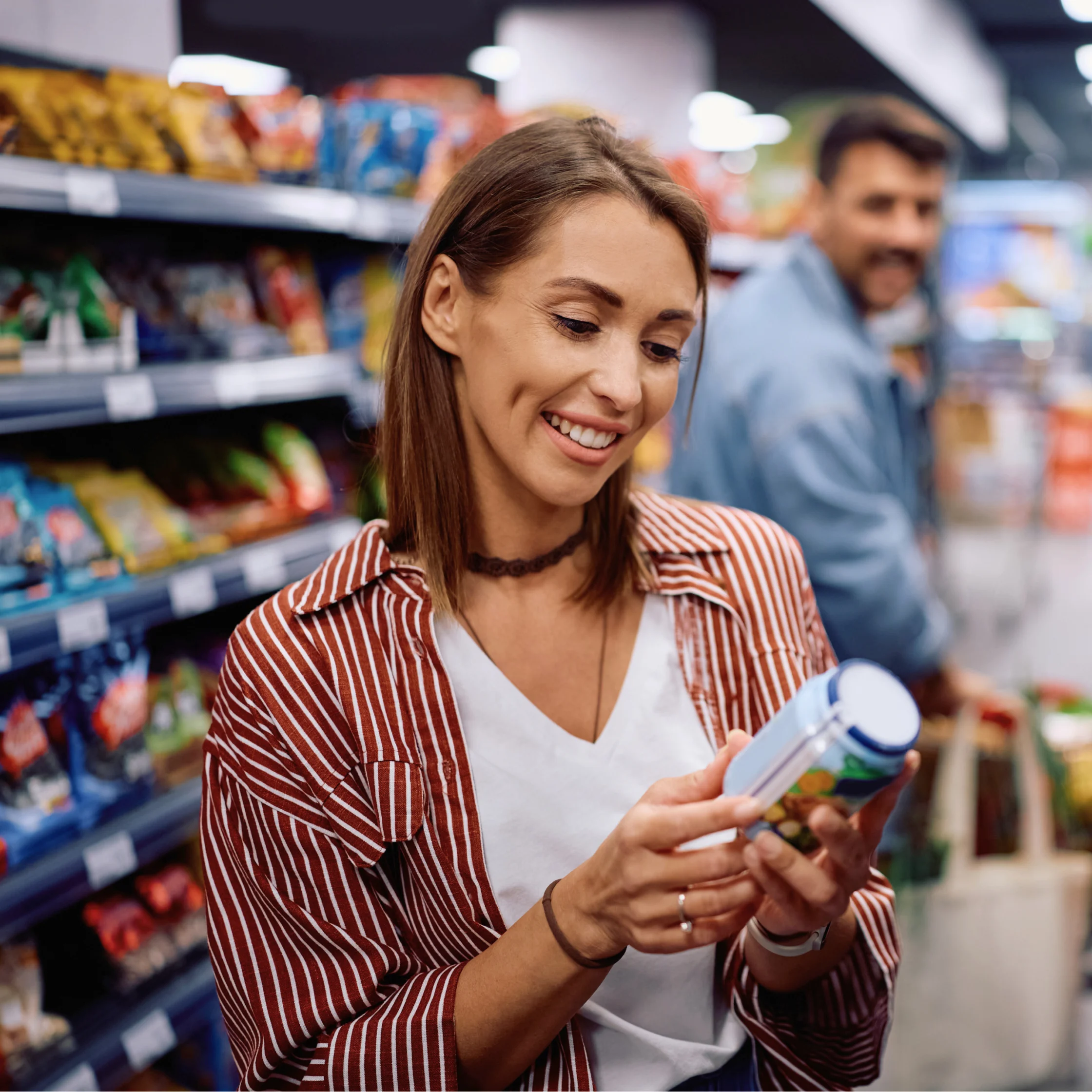 woman checking nutrition labels in grocery store