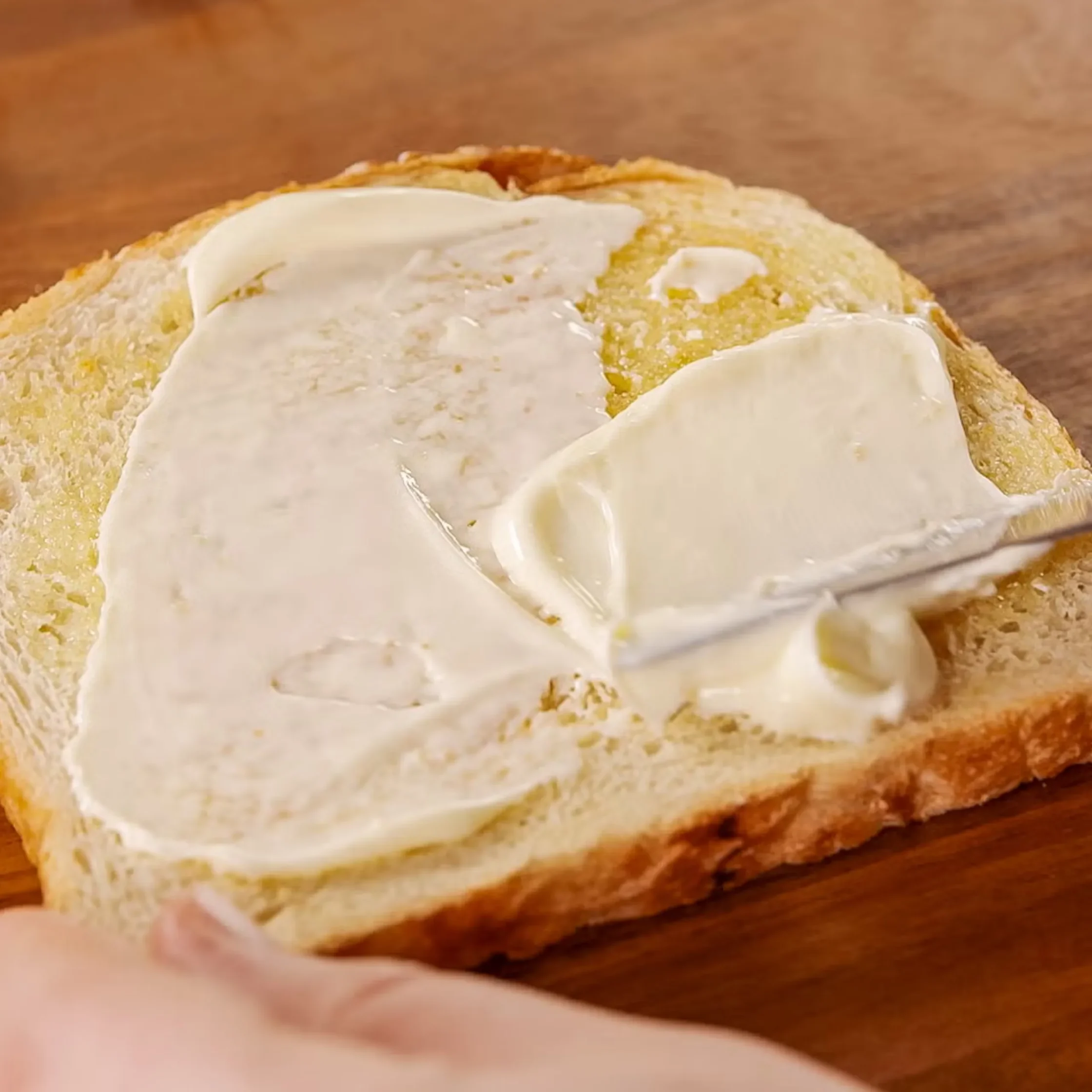 Once toasted, spread a thin layer of butter on both sides.