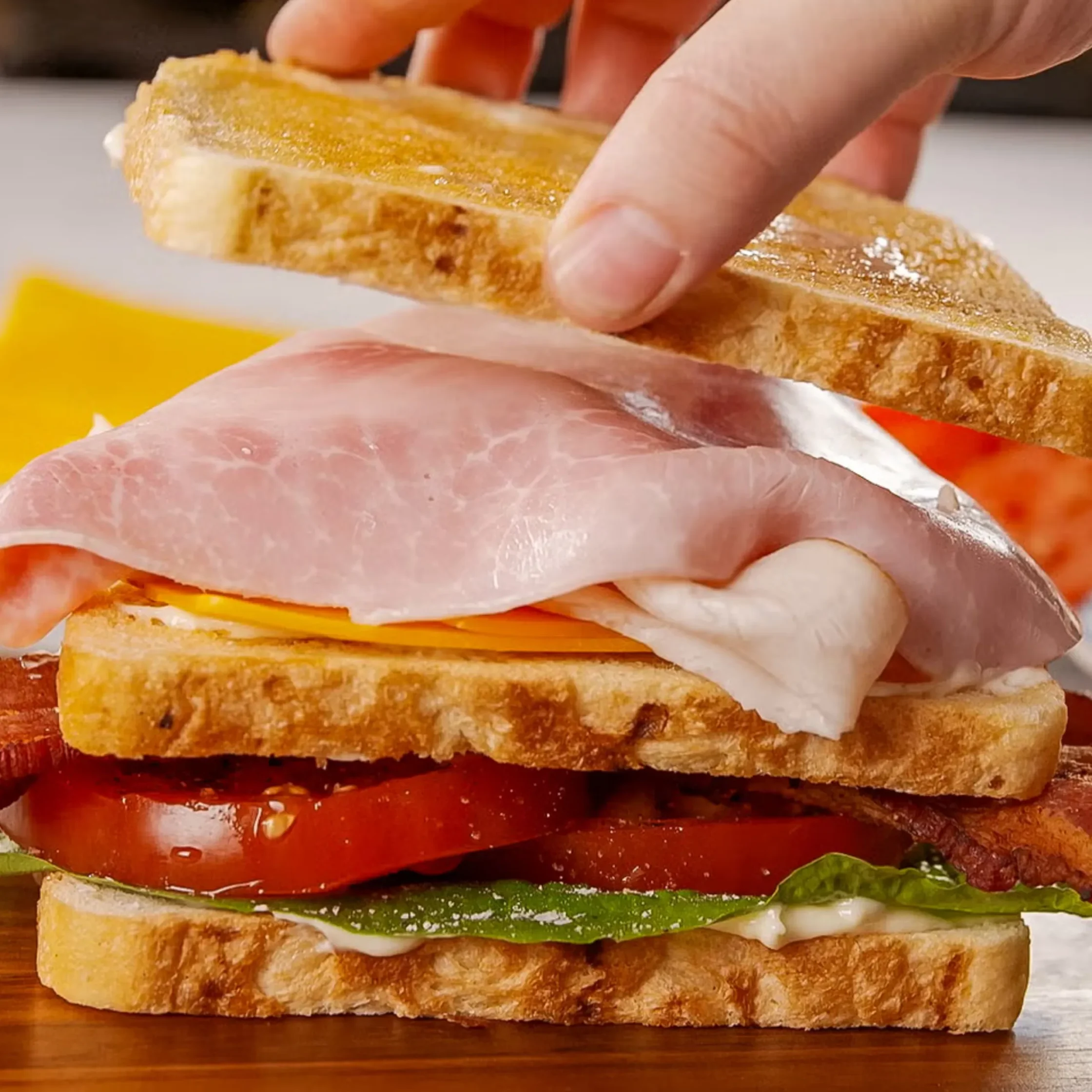 Stack up the cheddar, then turkey, then ham.