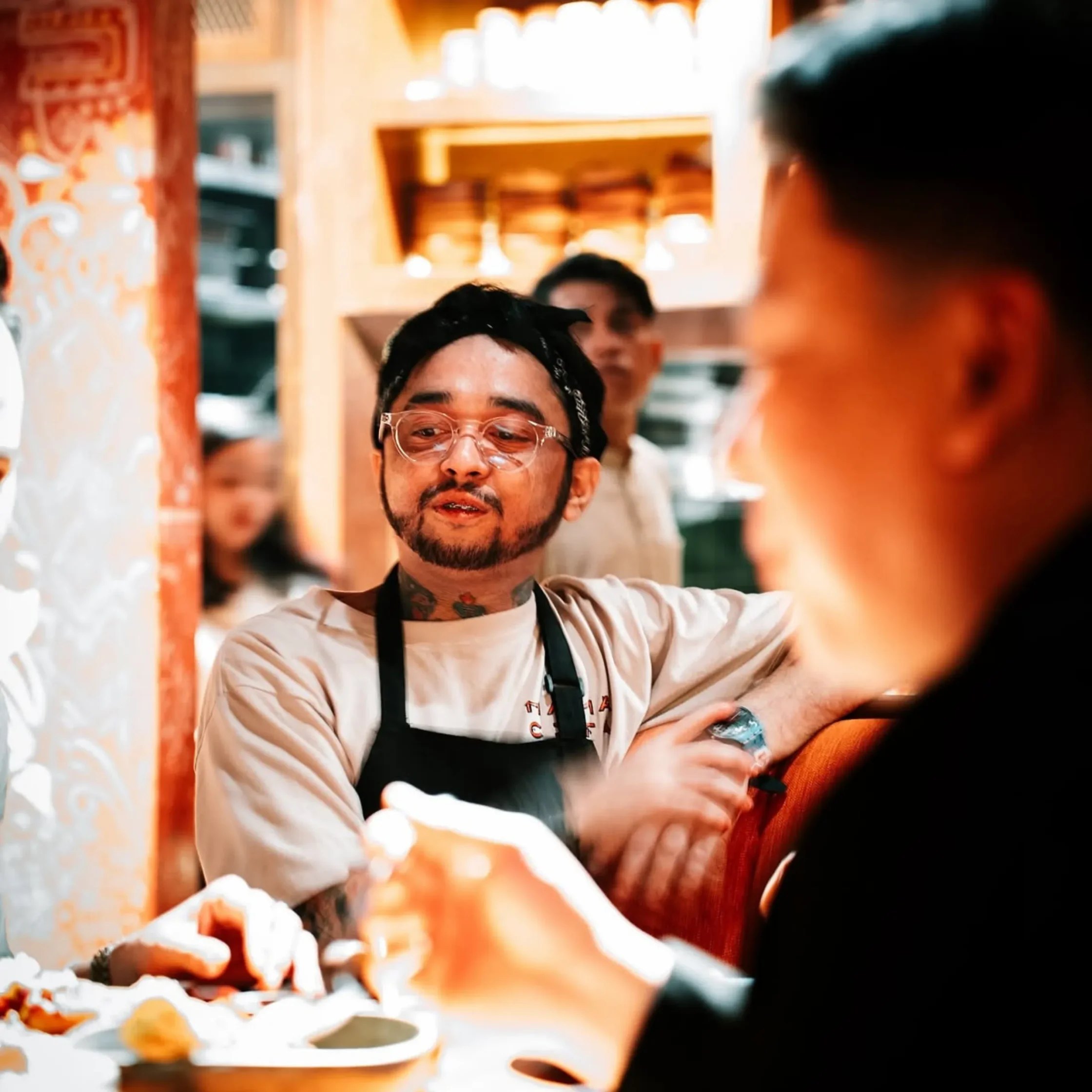 Charles Montanez watching standing by someone serving food